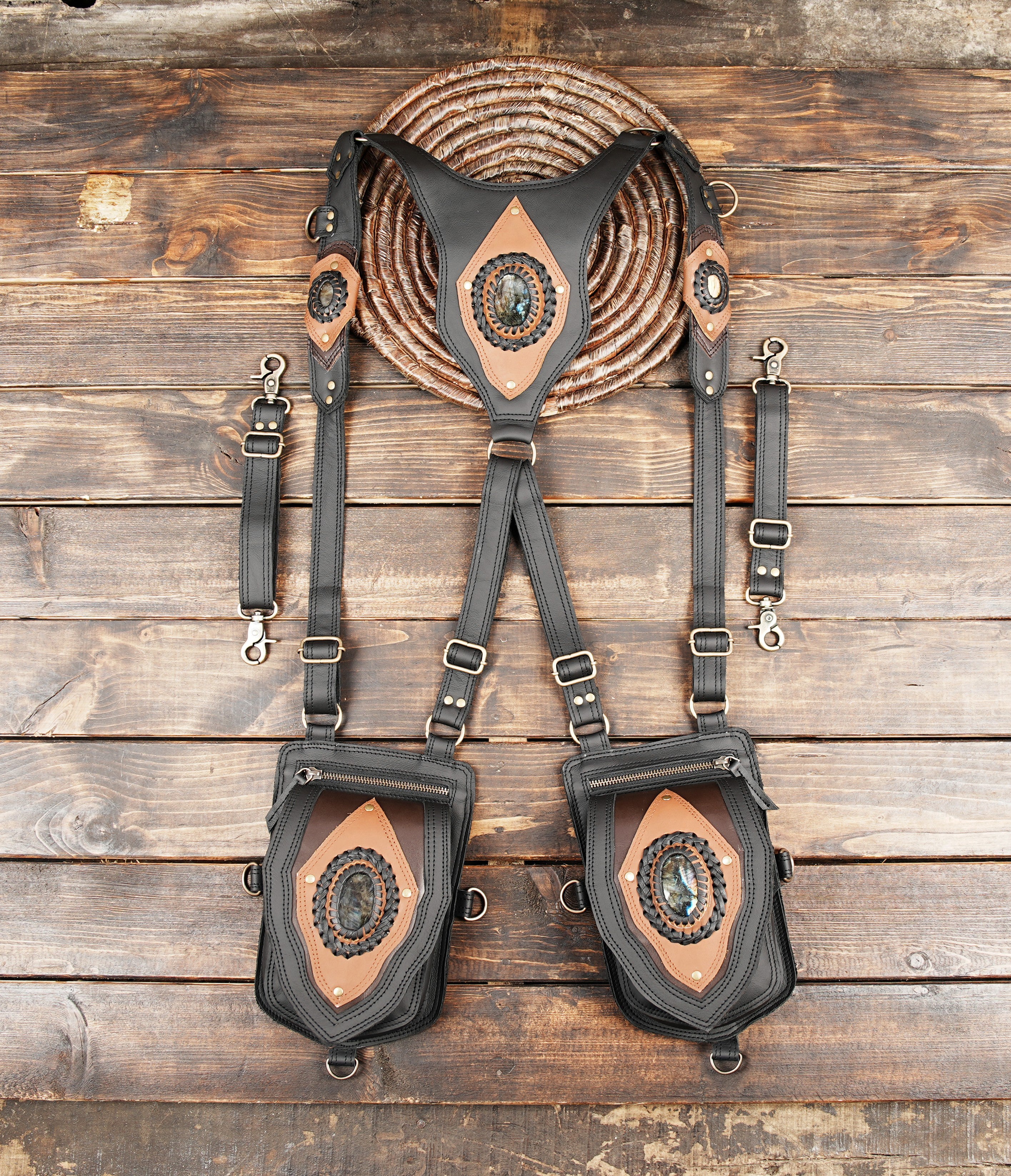black harness holster bag with tan leather accent and gemstone centerpiece