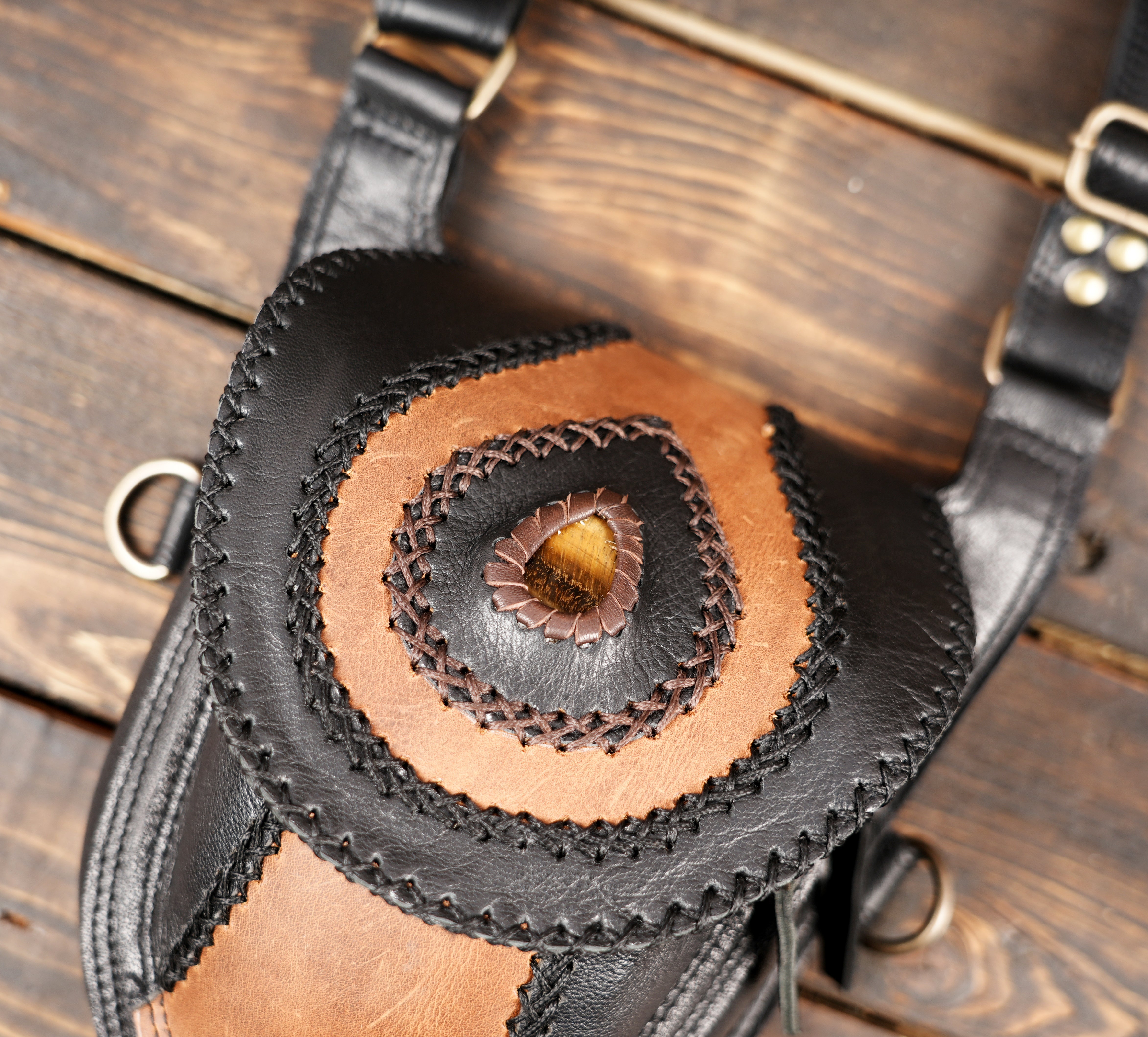 Black and brown leather holster with compact pouch design