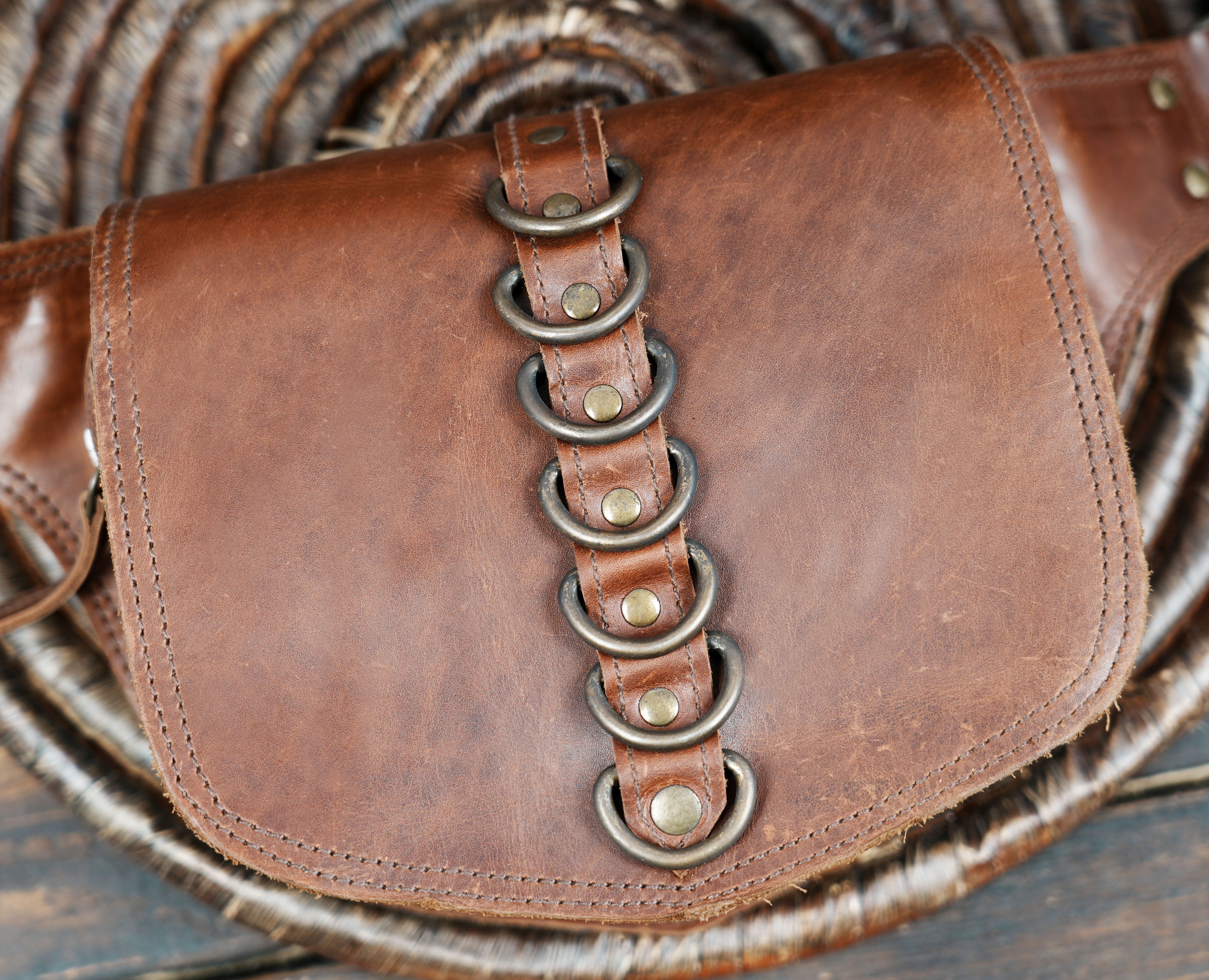 Brown leather belt bag with industrial ring accents
