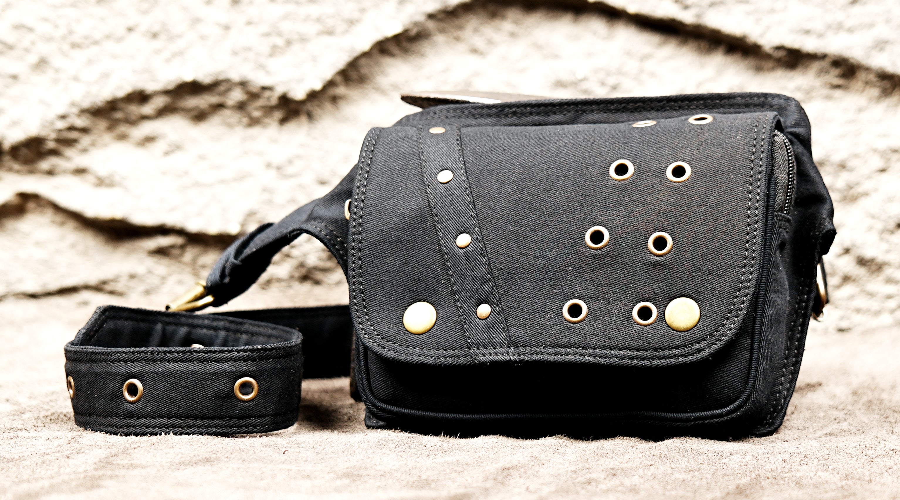 Black festival hip pouch with antique brass eyelets and front flap