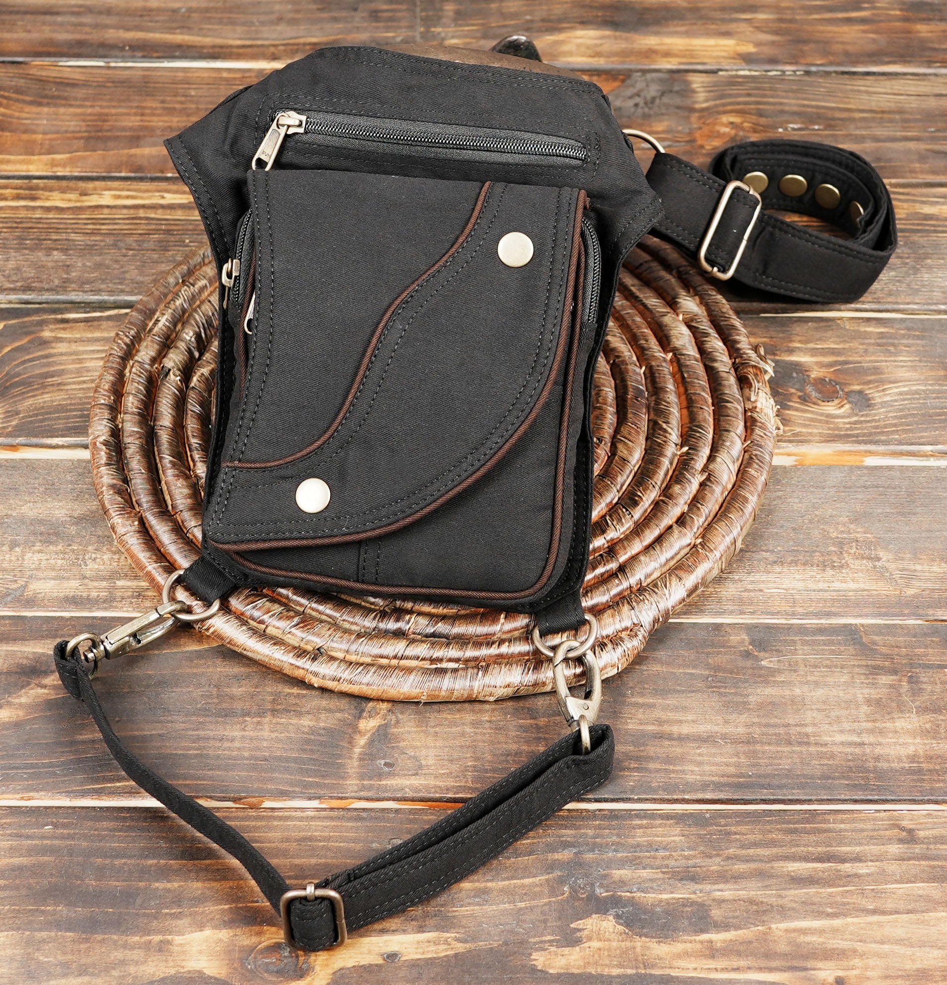 Hands-free festival utility hip pouch with adjustable waist strap and lower leg fastener.