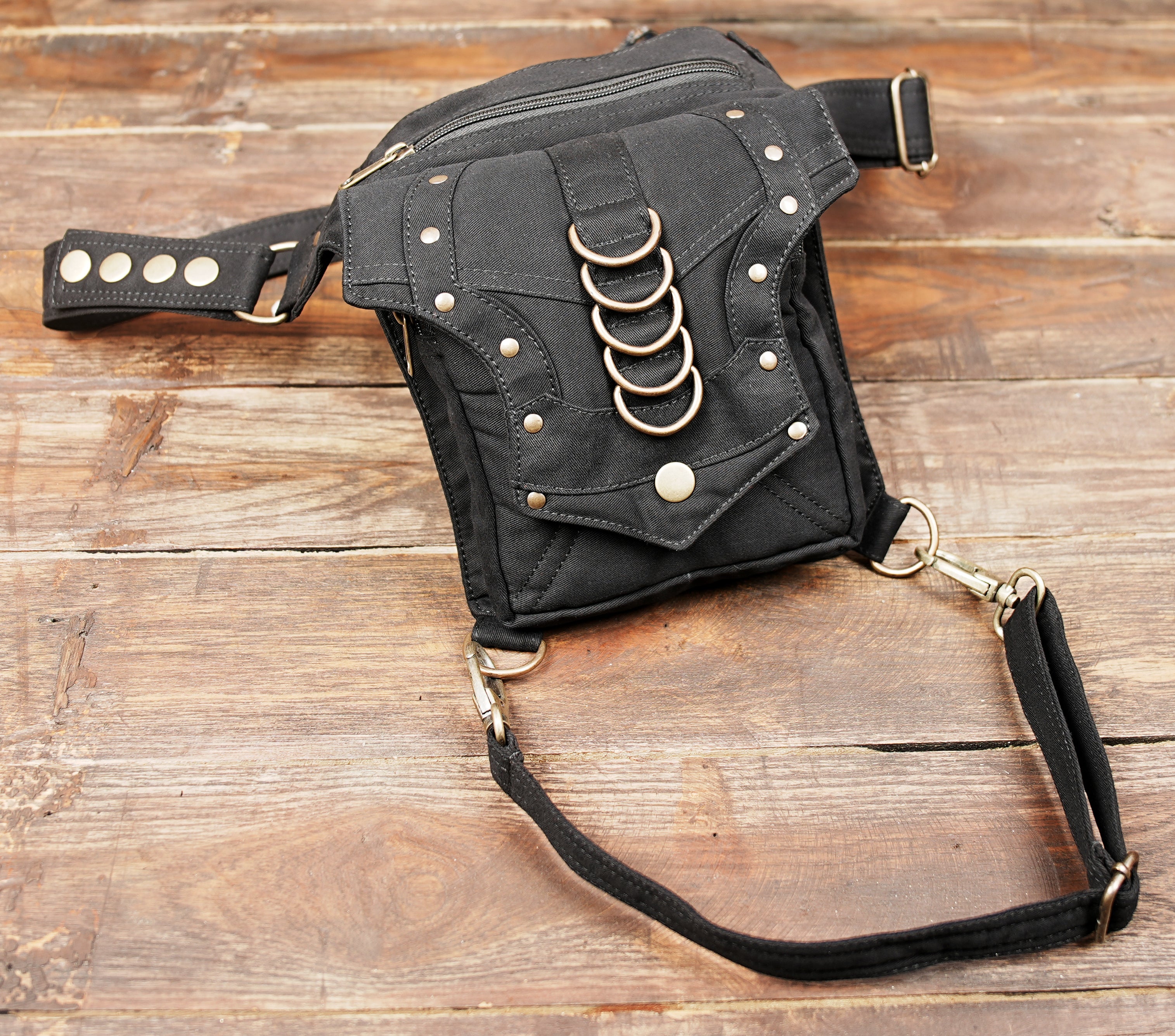 Hands-free festival utility hip pouch with adjustable waist and leg strap fasteners.
