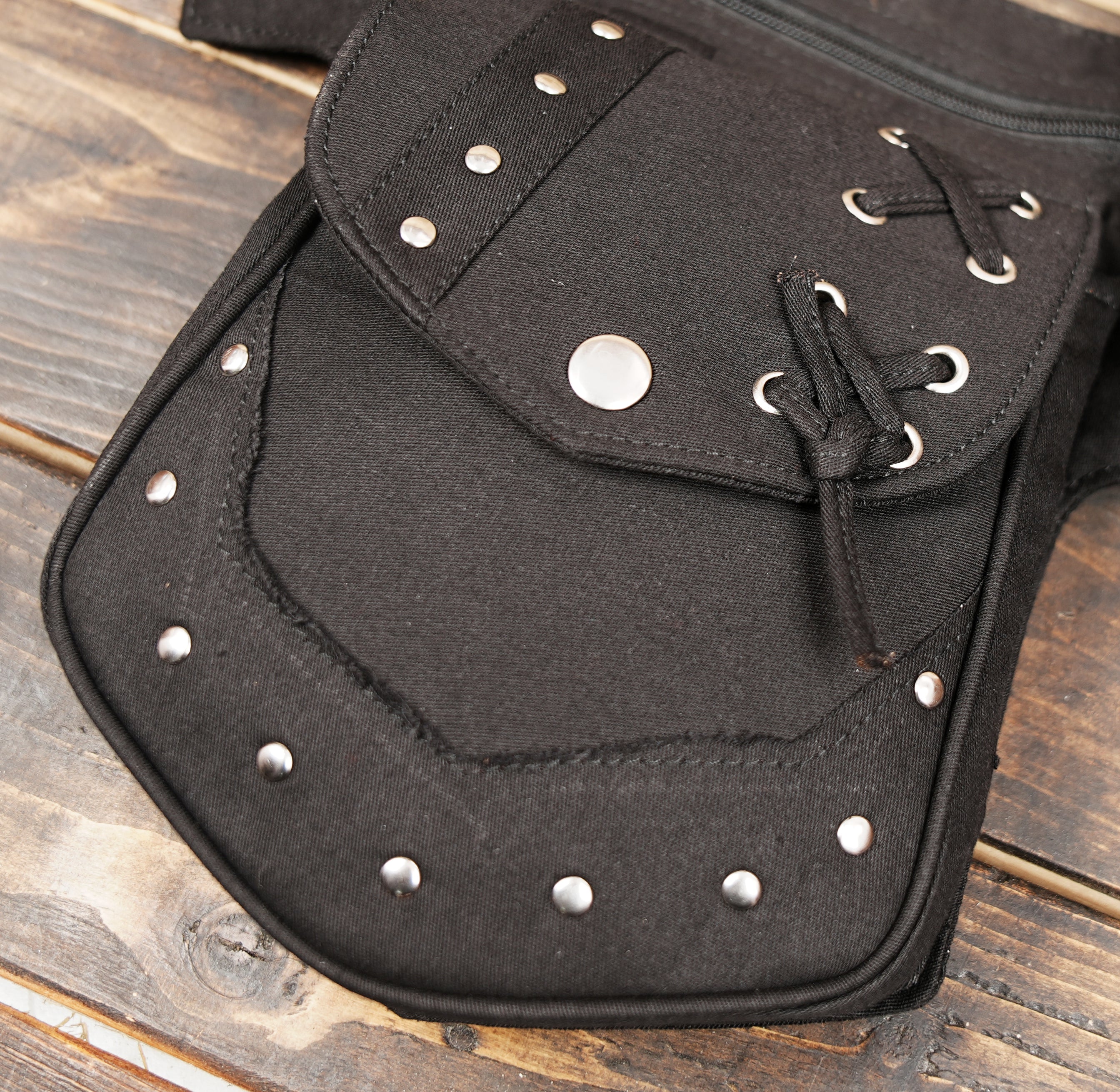 Black cotton utility waist belt bag with multiple pockets and adjustable strap