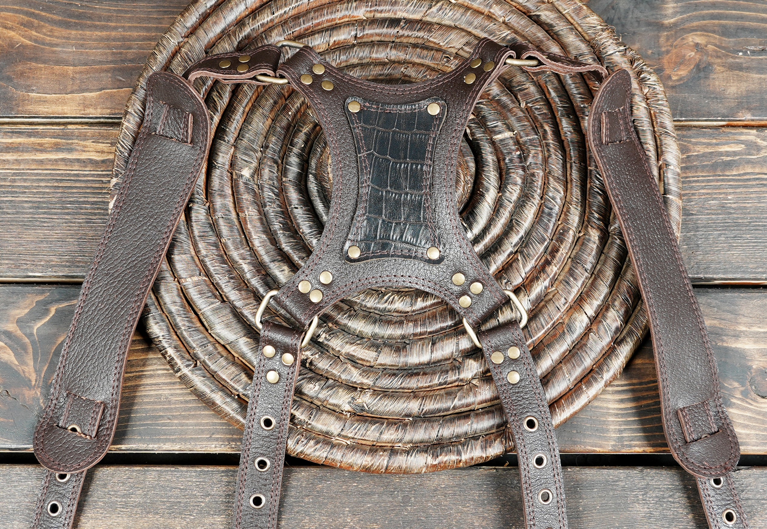 Durable leather gun holster shoulder rig with metal rivet detailing