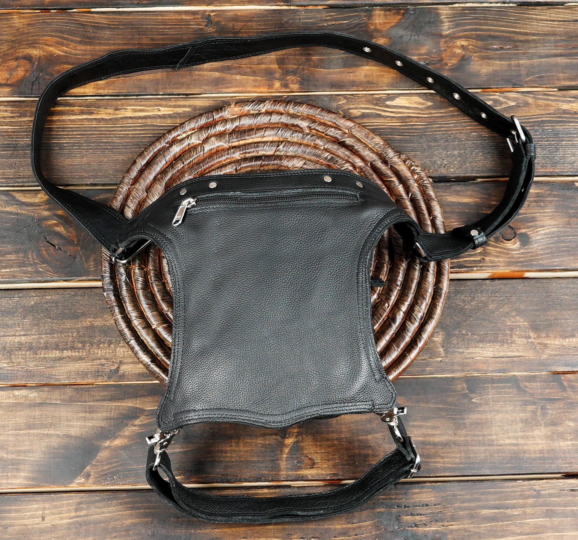 Black and red leather waist bag styled as a thigh holster with gothic design