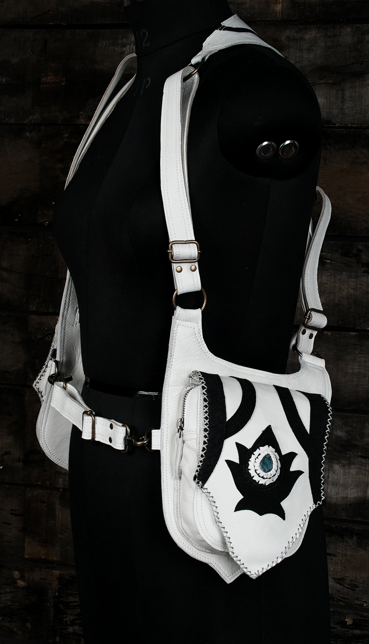 “White double holster bag with artistic black design and secure flaps”
