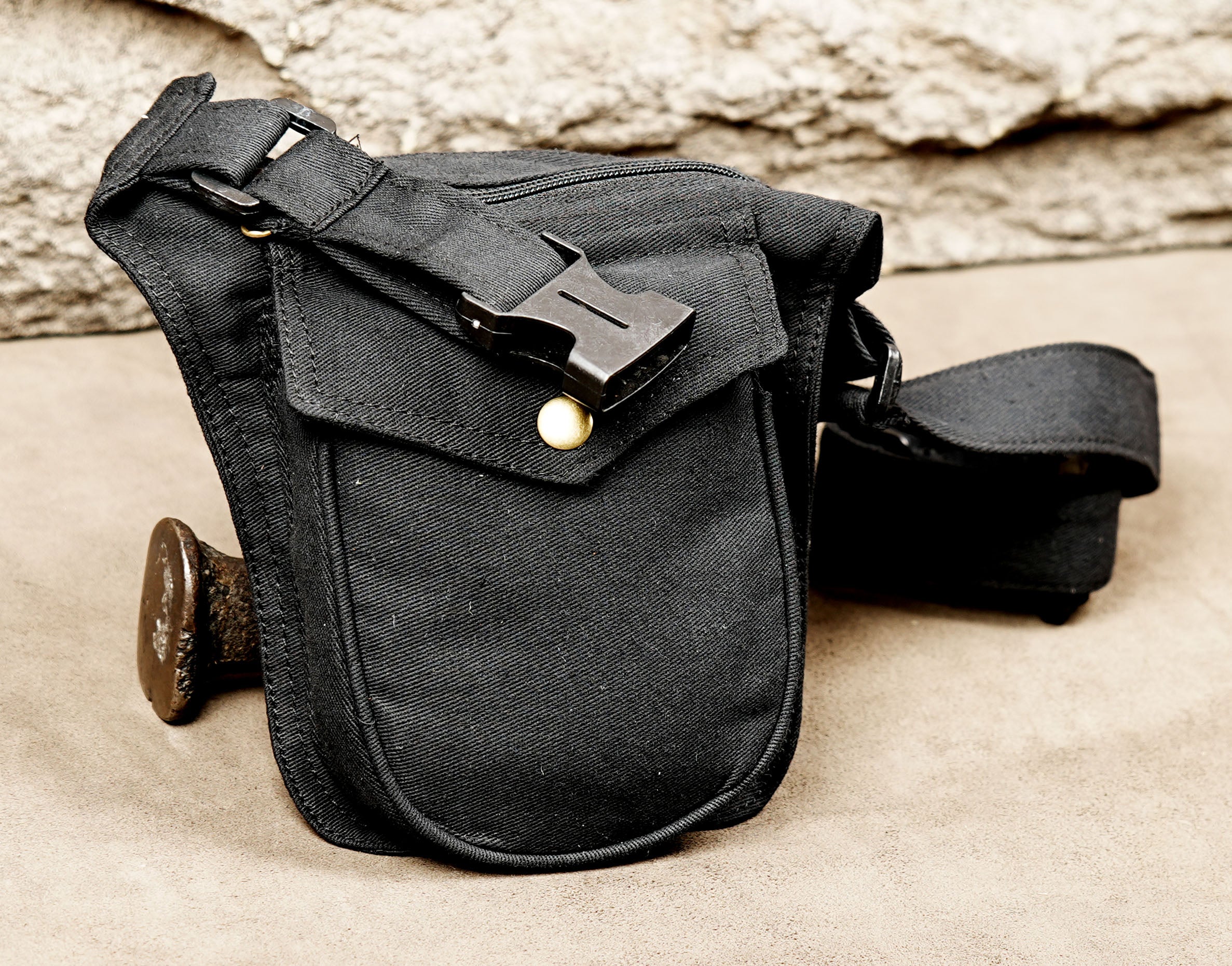 Black leg bag style pouch with snap button flap