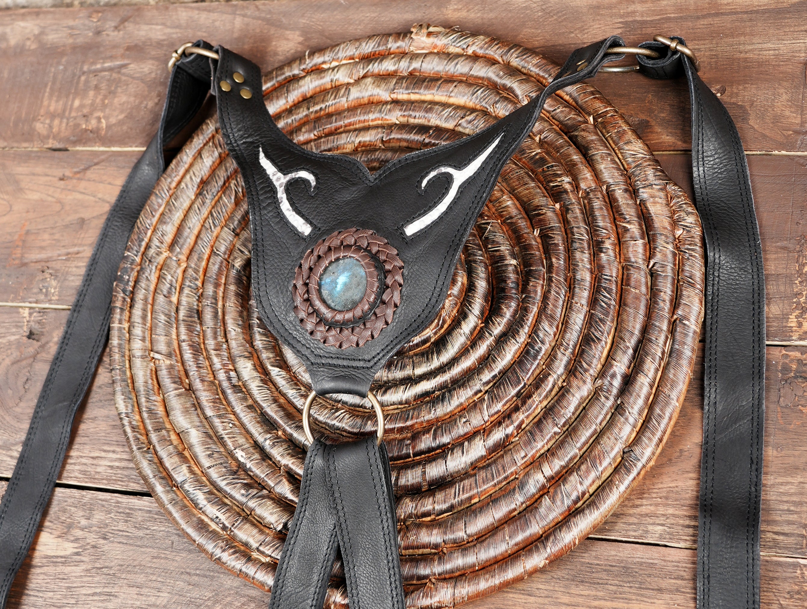 Close-up of premium leather craftsmanship with brass studs on utility holster bag