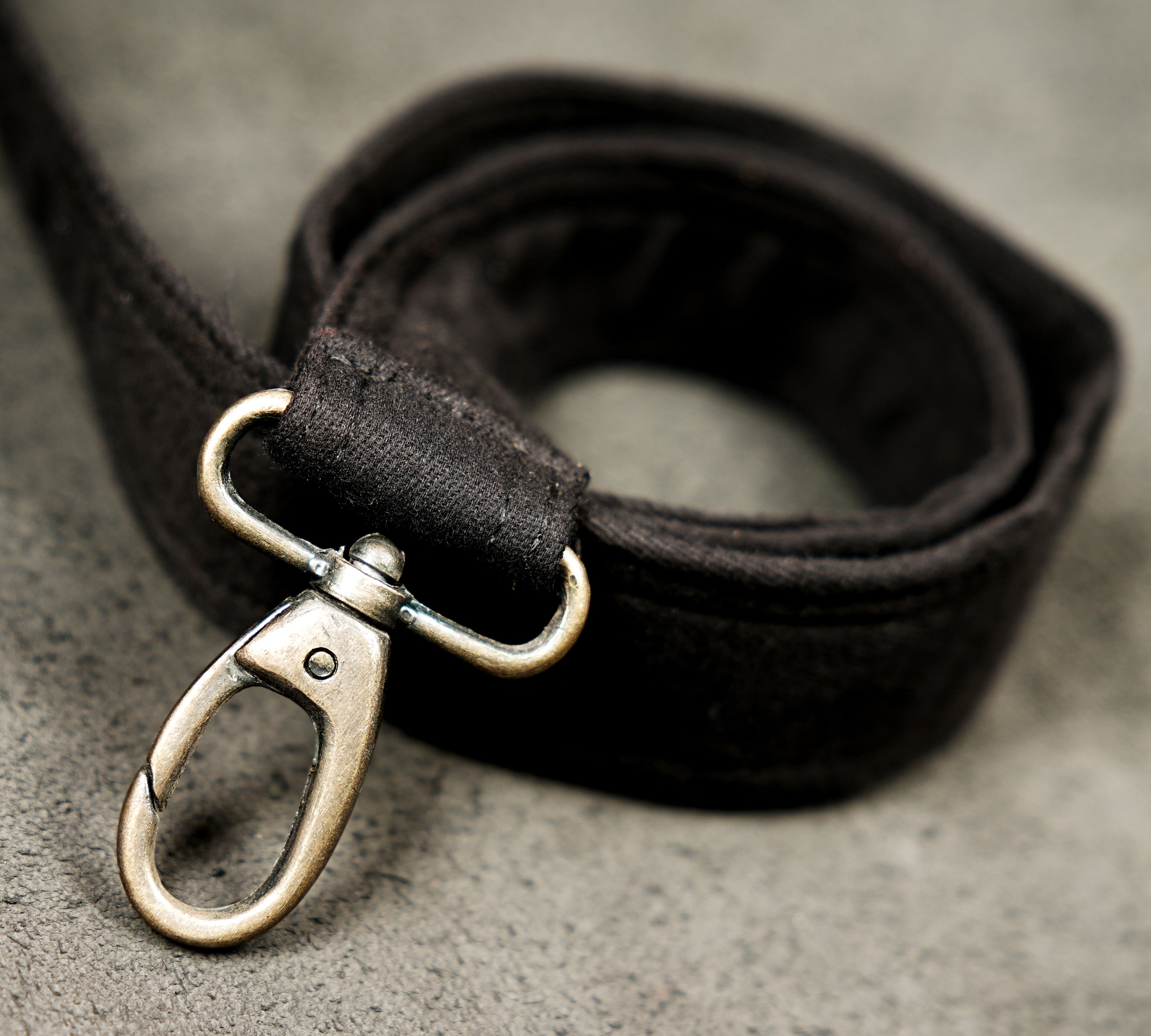 This canvas belt pouch features a central flap pocket with a chevron-shaped studded strap.