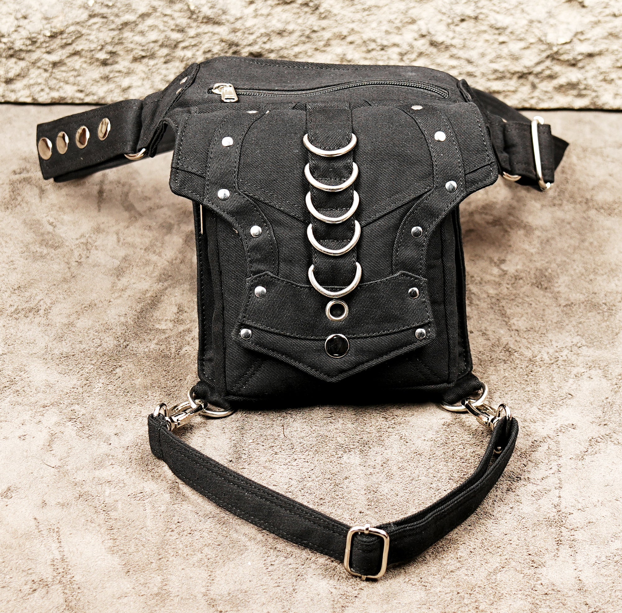 Industrial punk style black canvas drop leg bag with decorative rings