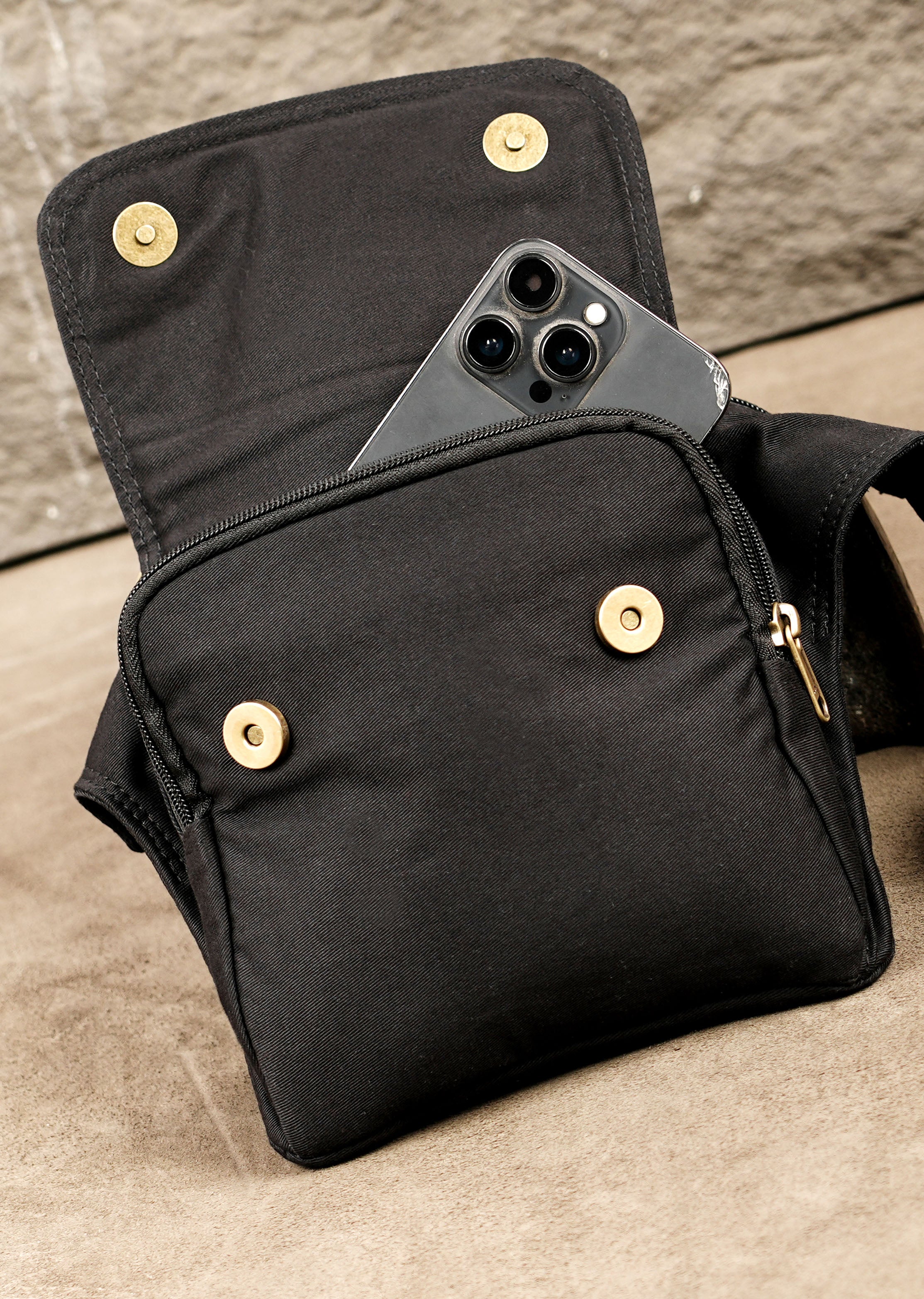 Unisex black cotton waist bag with flap pocket and front zip compartment