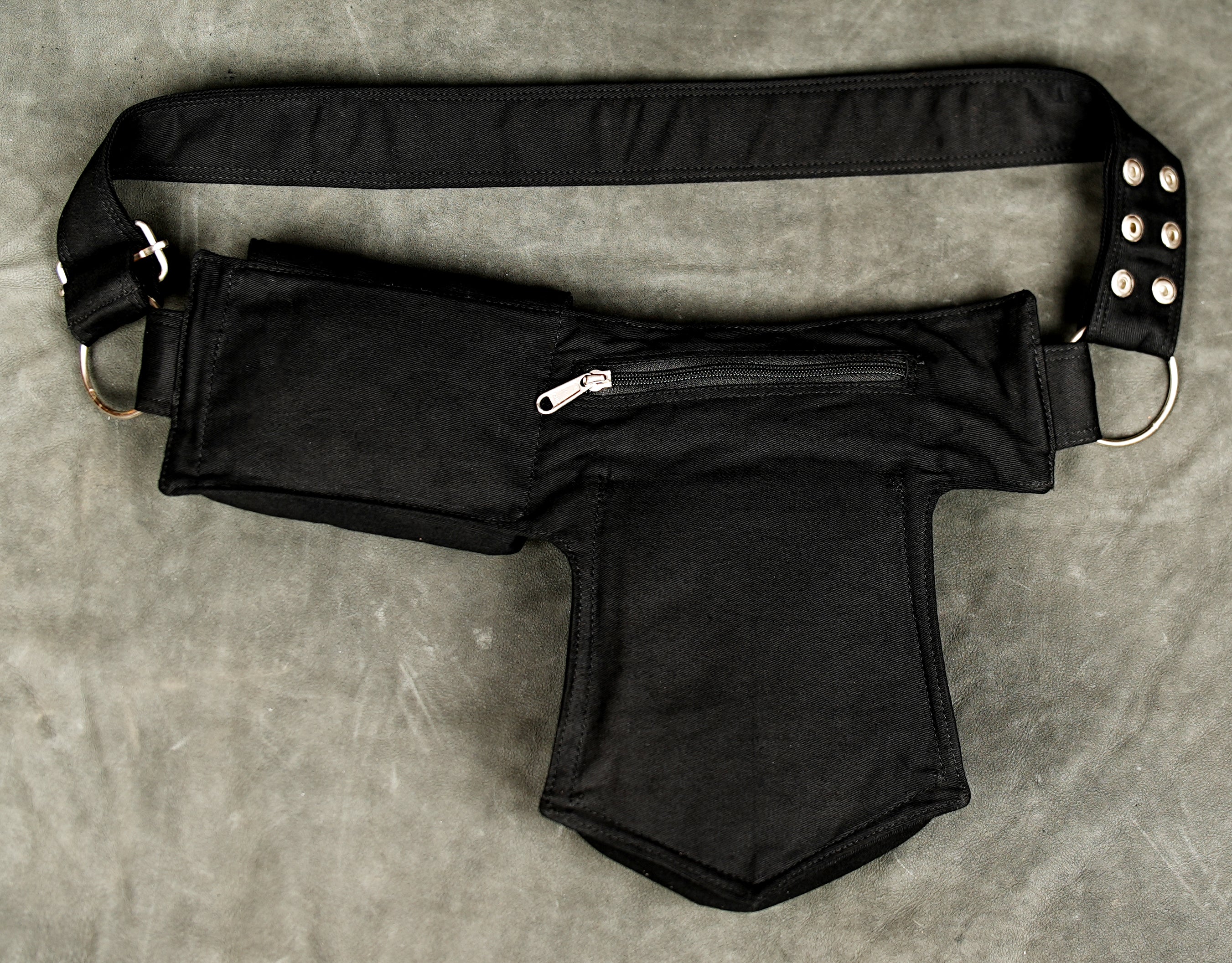 Black cotton waist pouch belt with adjustable buckle and multiple pockets for everyday essentials.