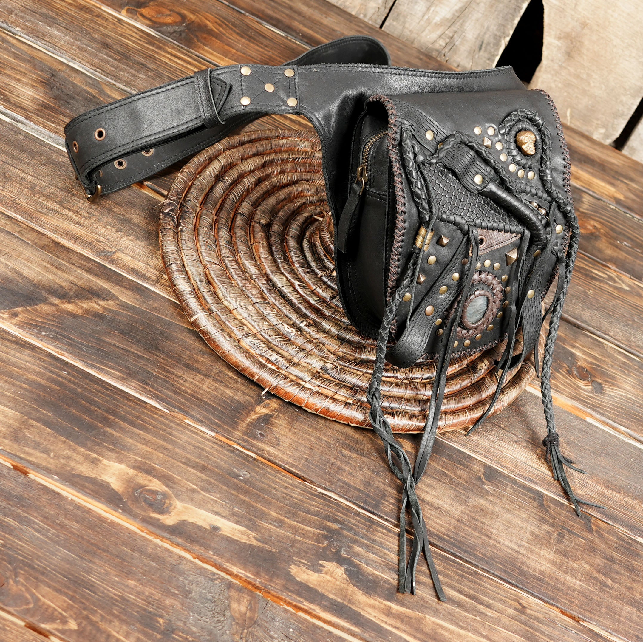 Adjustable black leather waist bag with fringe accents