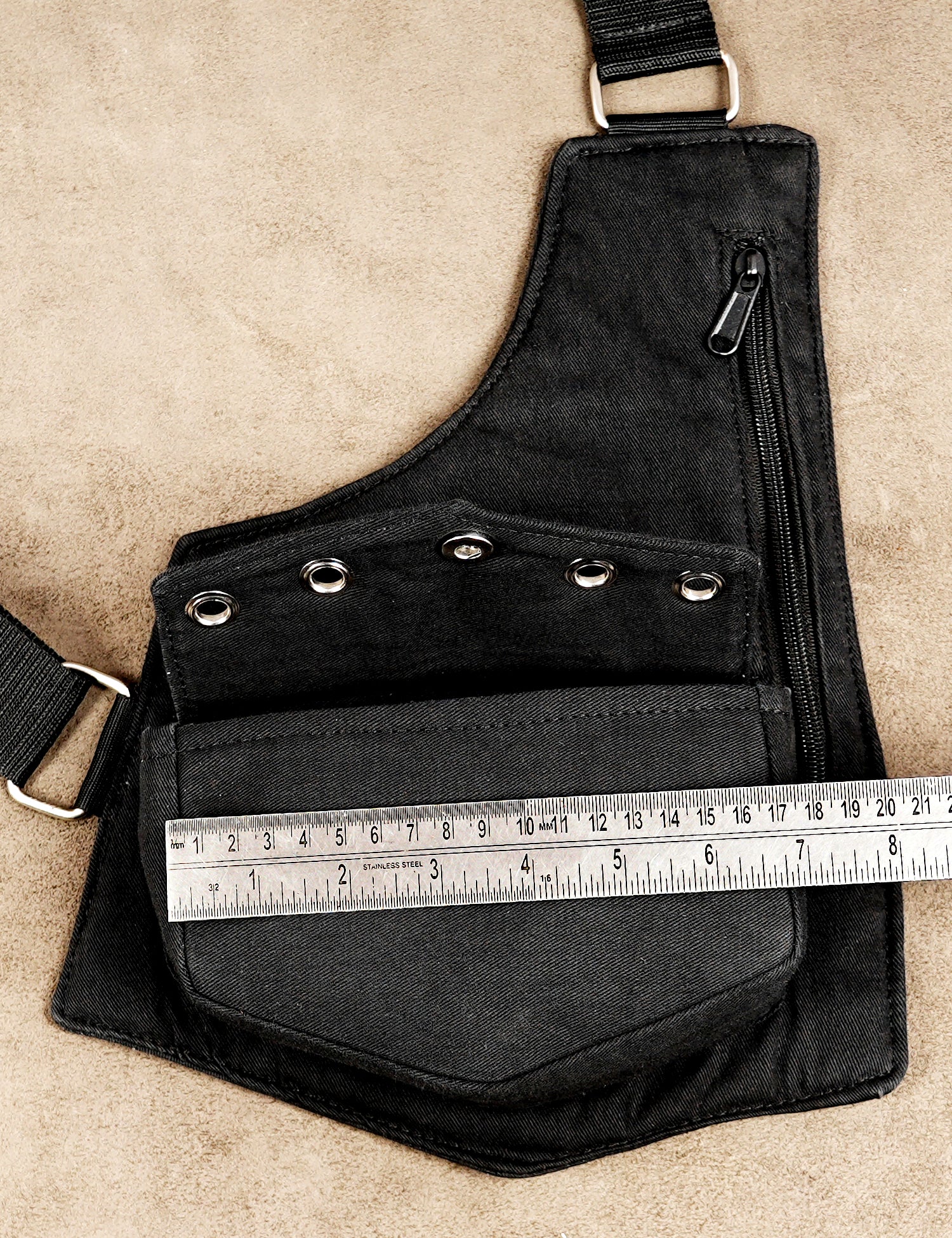 Black harness bag with front zip and snap closures