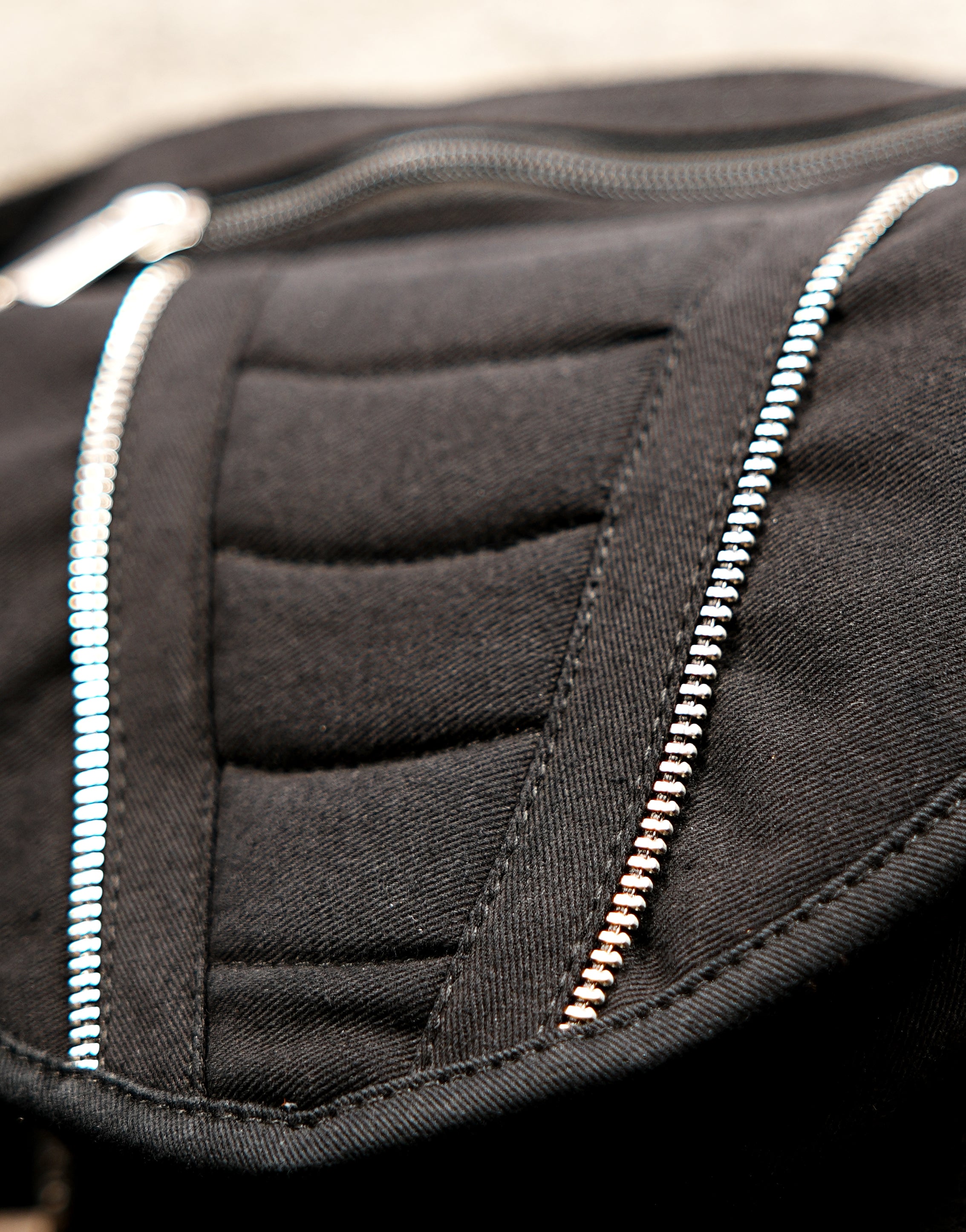 Stylish black belt bag with silver metal zippers