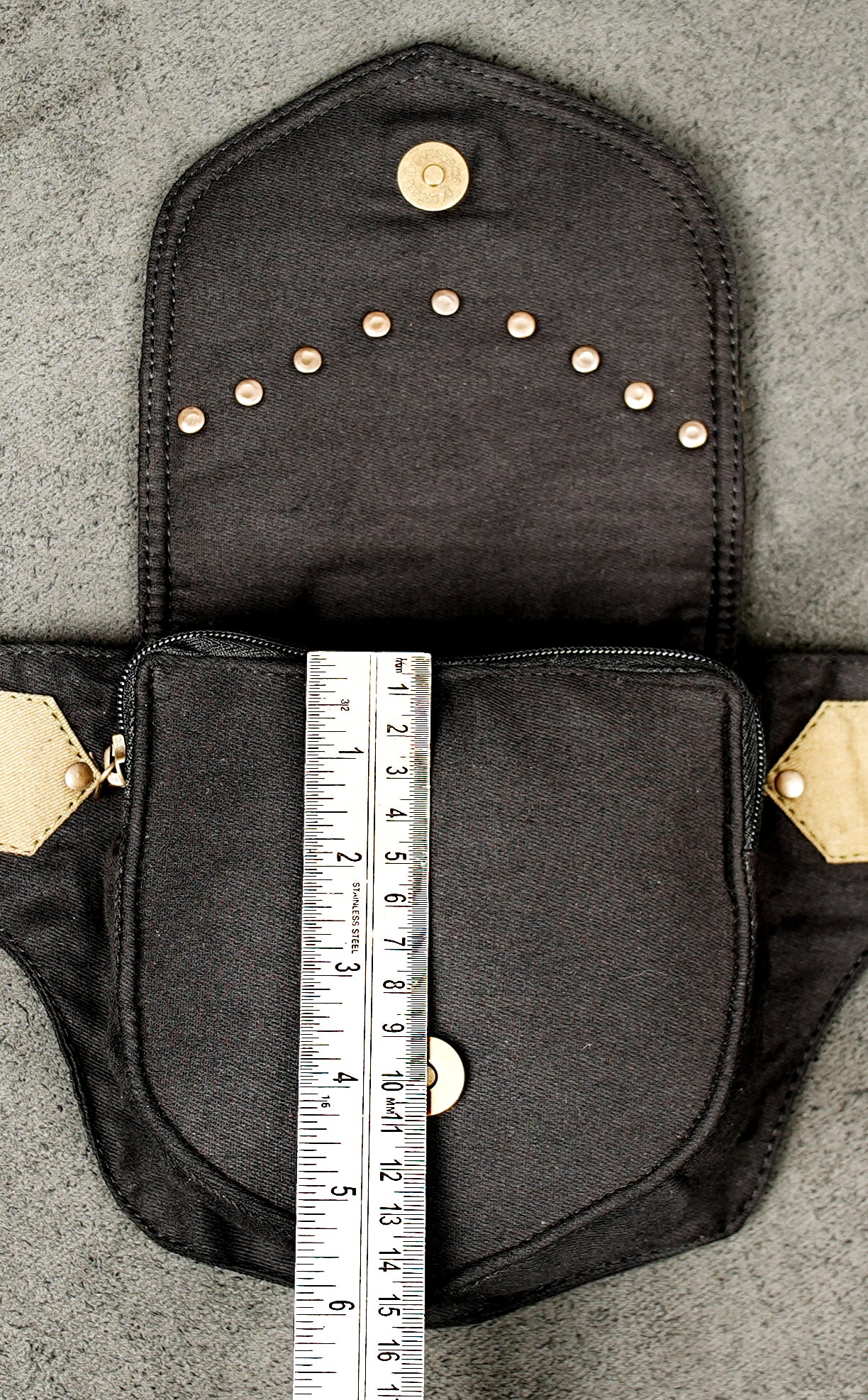 This black cotton bumbag (Europe) / waist pouch has a subtle steampunk or utilitarian aesthetic.