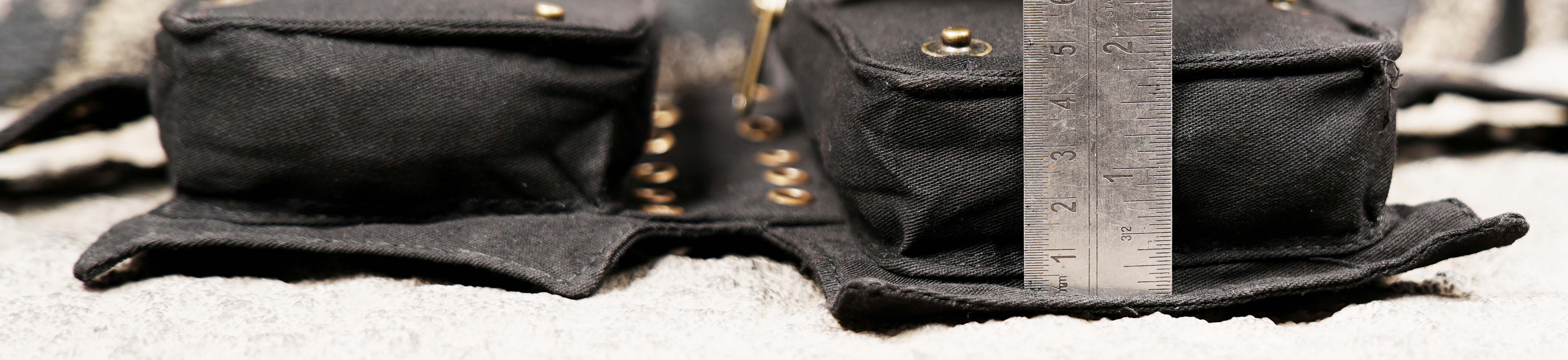 Black cotton waist pack with lace-up pockets and adjustable strap