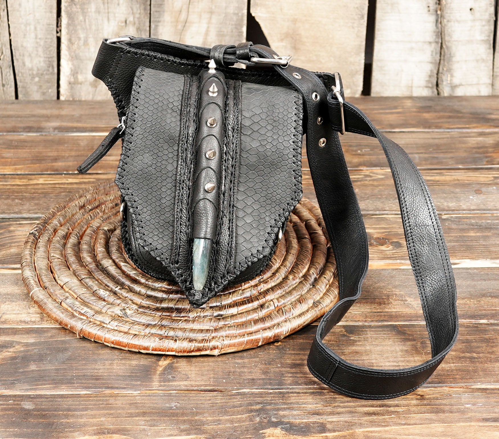 Black leather waist belt with textured panels and horn tip