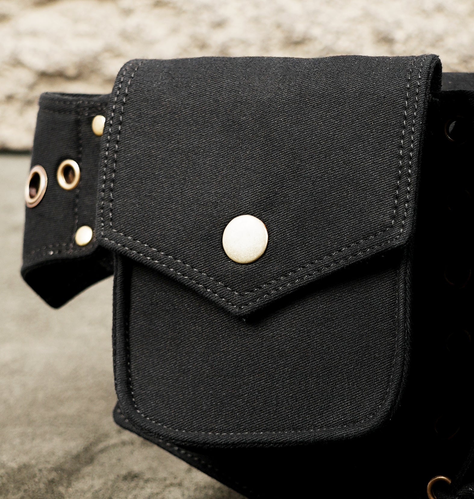 Black hip pouch belt with multiple compartments for festival essentials