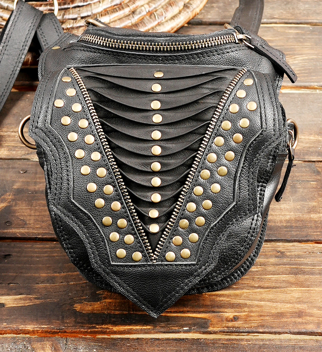 “Artisan black leather festival holster with textured panels and adjustable straps”