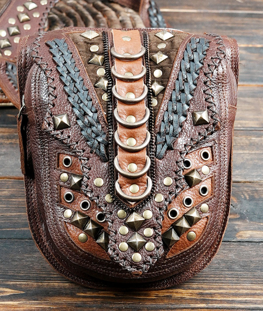 leather holster rig with skull studs and woven panel design”