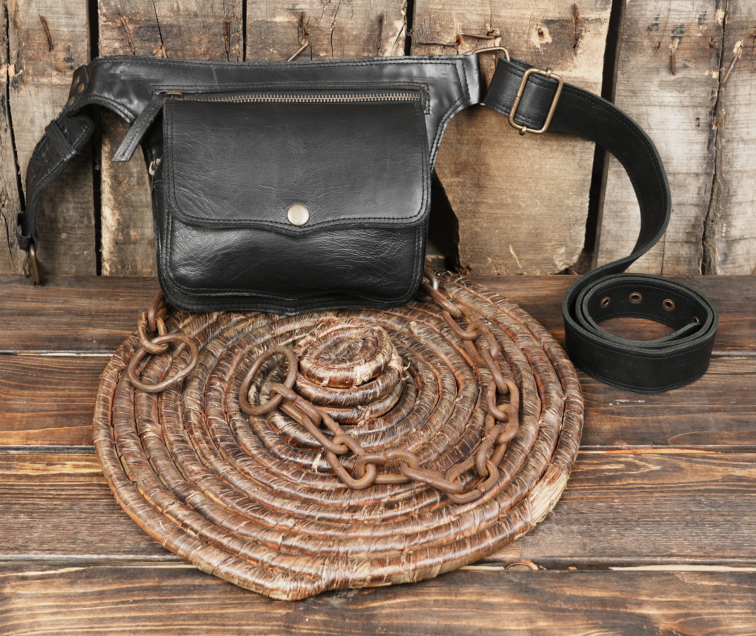 Sleek black leather waist pack with secure closures