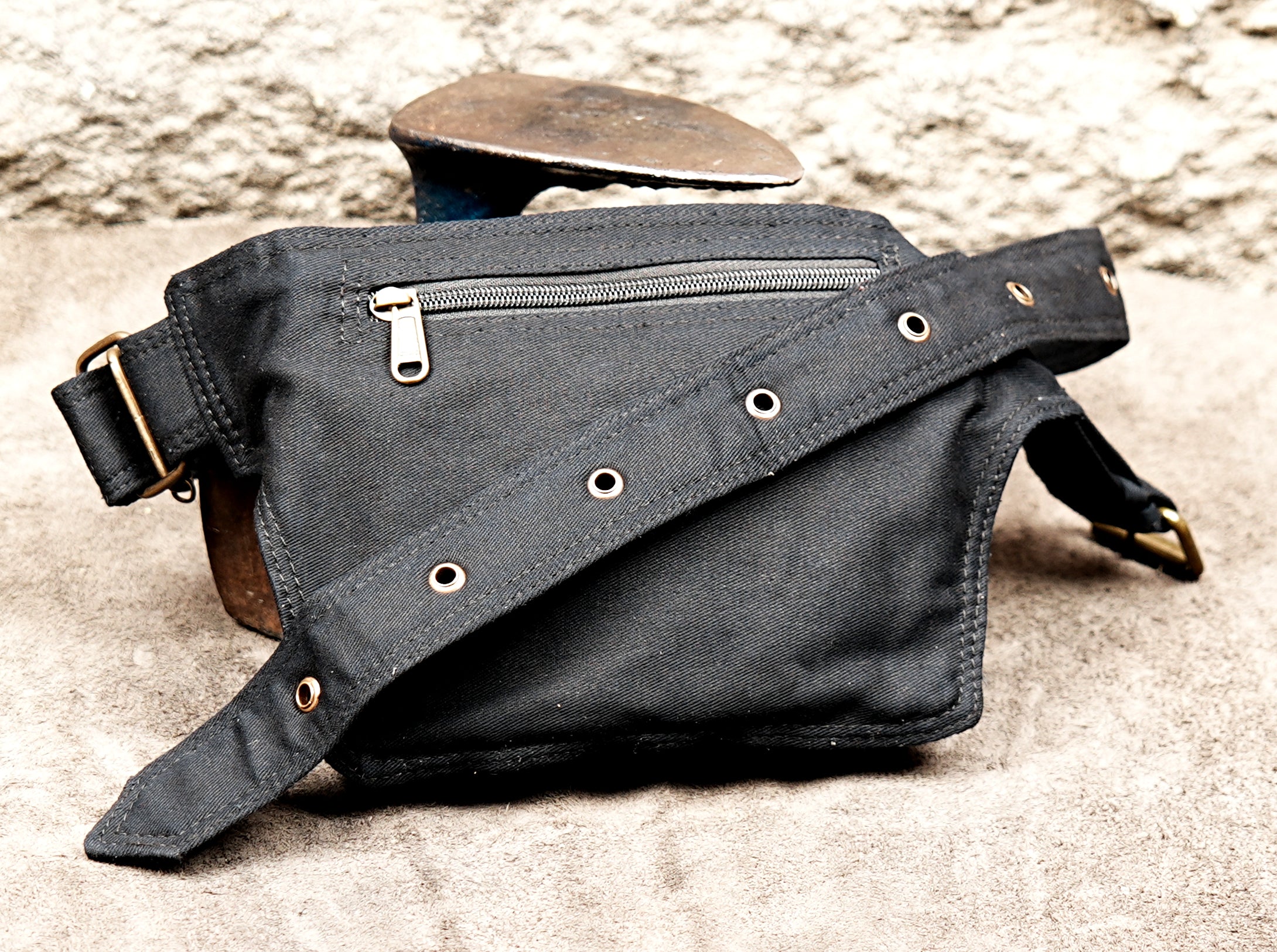 Black cotton travel belt bag with decorative brass studs and eyelets