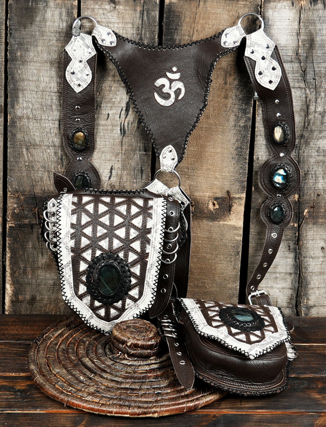 Adjustable leather harness bag with gemstone accent and detailed patterns