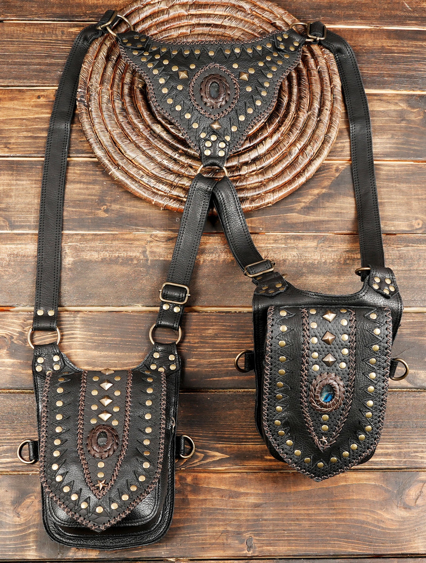 Handmade leather holster harness displayed on wooden table