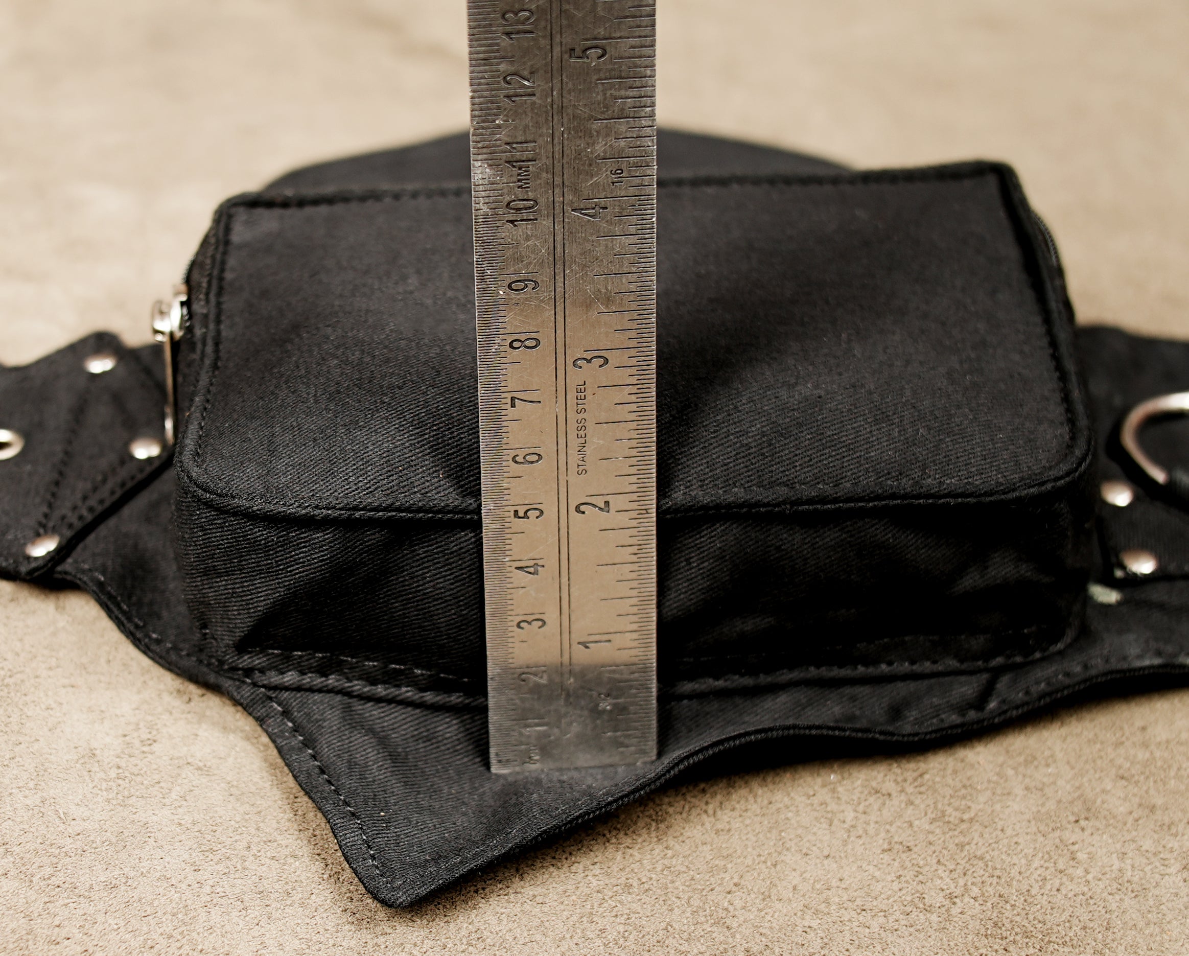 Adventure travel waist pack for hands-free carrying, in durable black canvas.