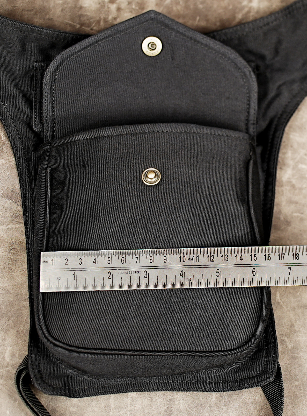 Black utility hip belt bag for travel, hiking, and festivals.