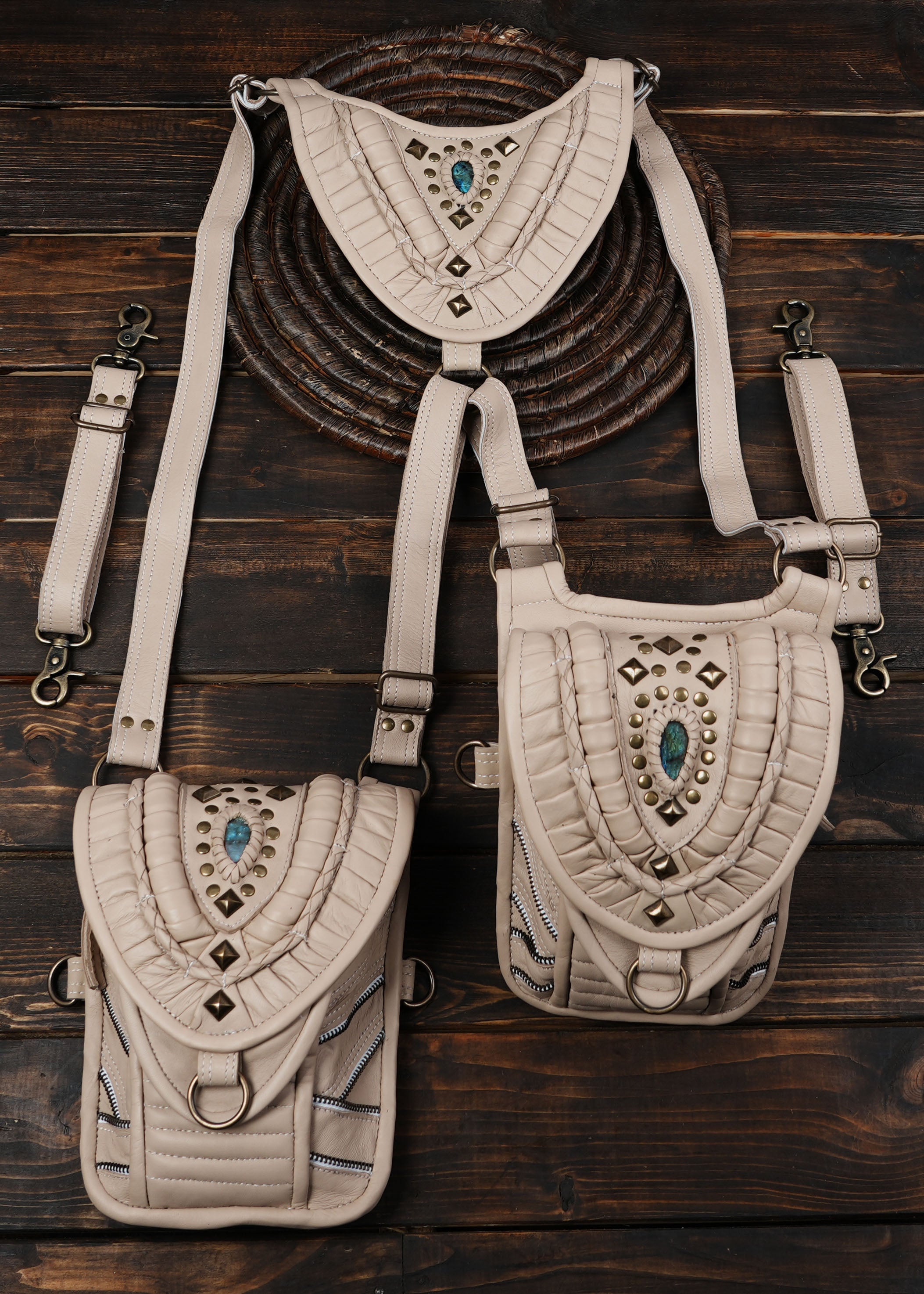 “Cream leather harness holster with decorative paneling and adjustable straps”