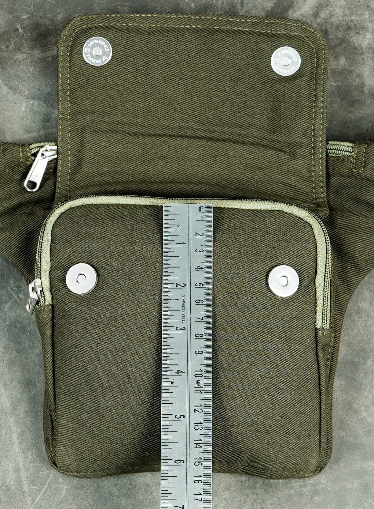 Olive green utility belt bag with front pocket and top zipper compartment