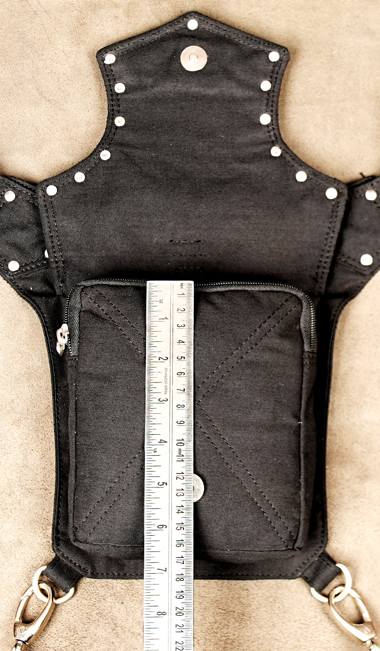 Close-up on the polished silver-tone buckle and sliding adjuster on the thigh strap.