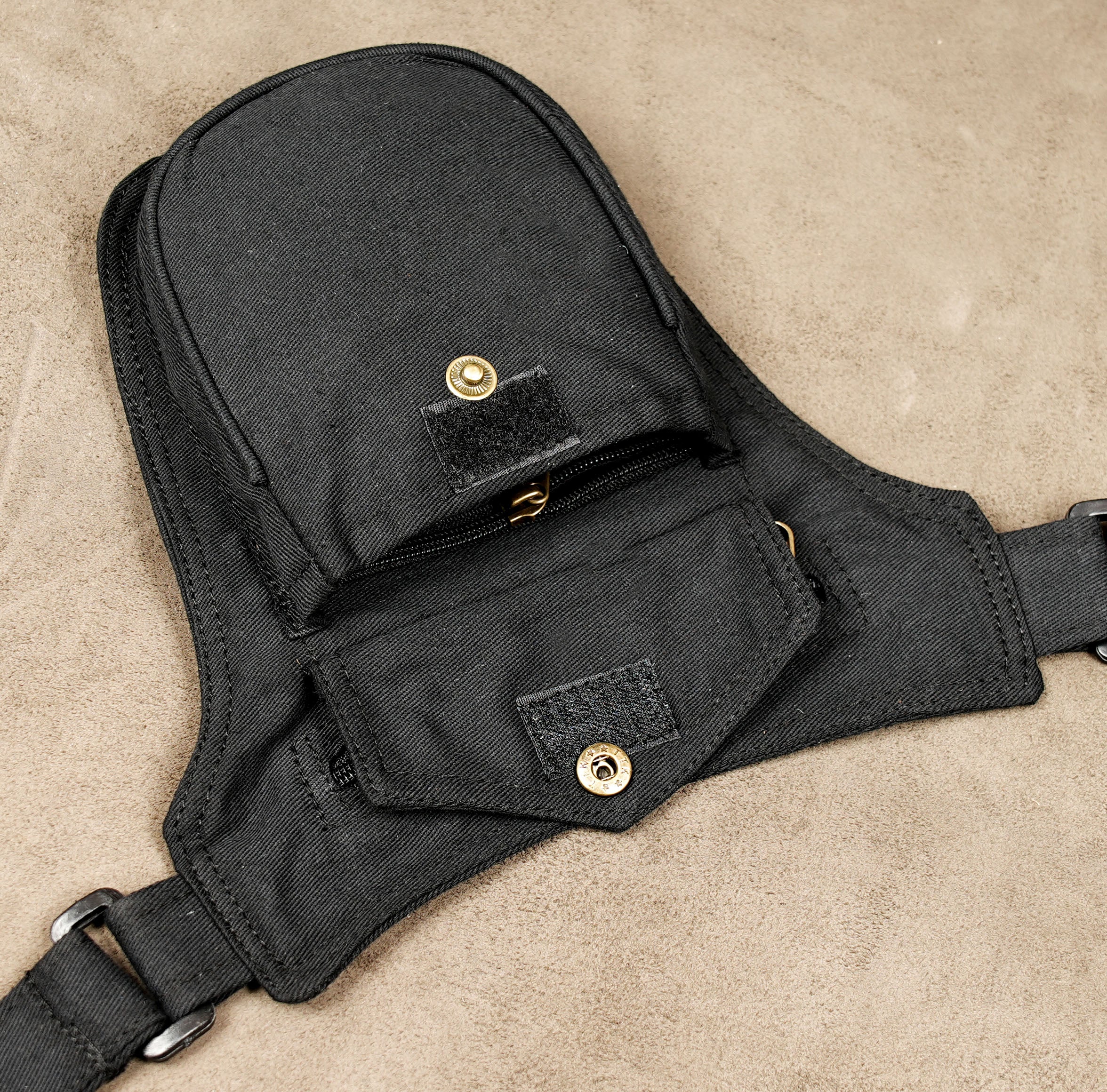 Minimalist black waist bag with brass zipper pull