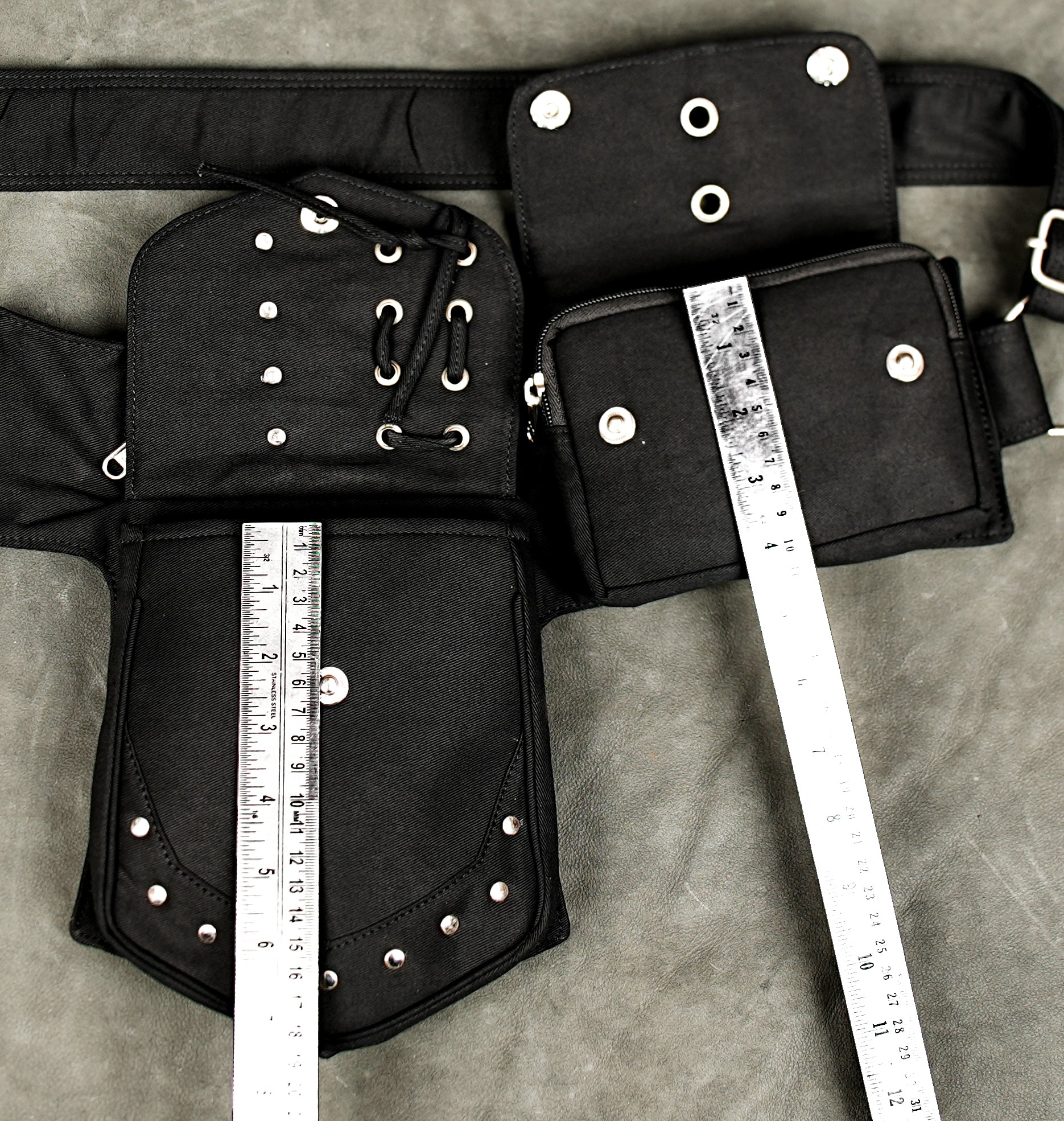 Black cotton utility waist pack with silver-tone studs and zippered storage for travel and festivals.