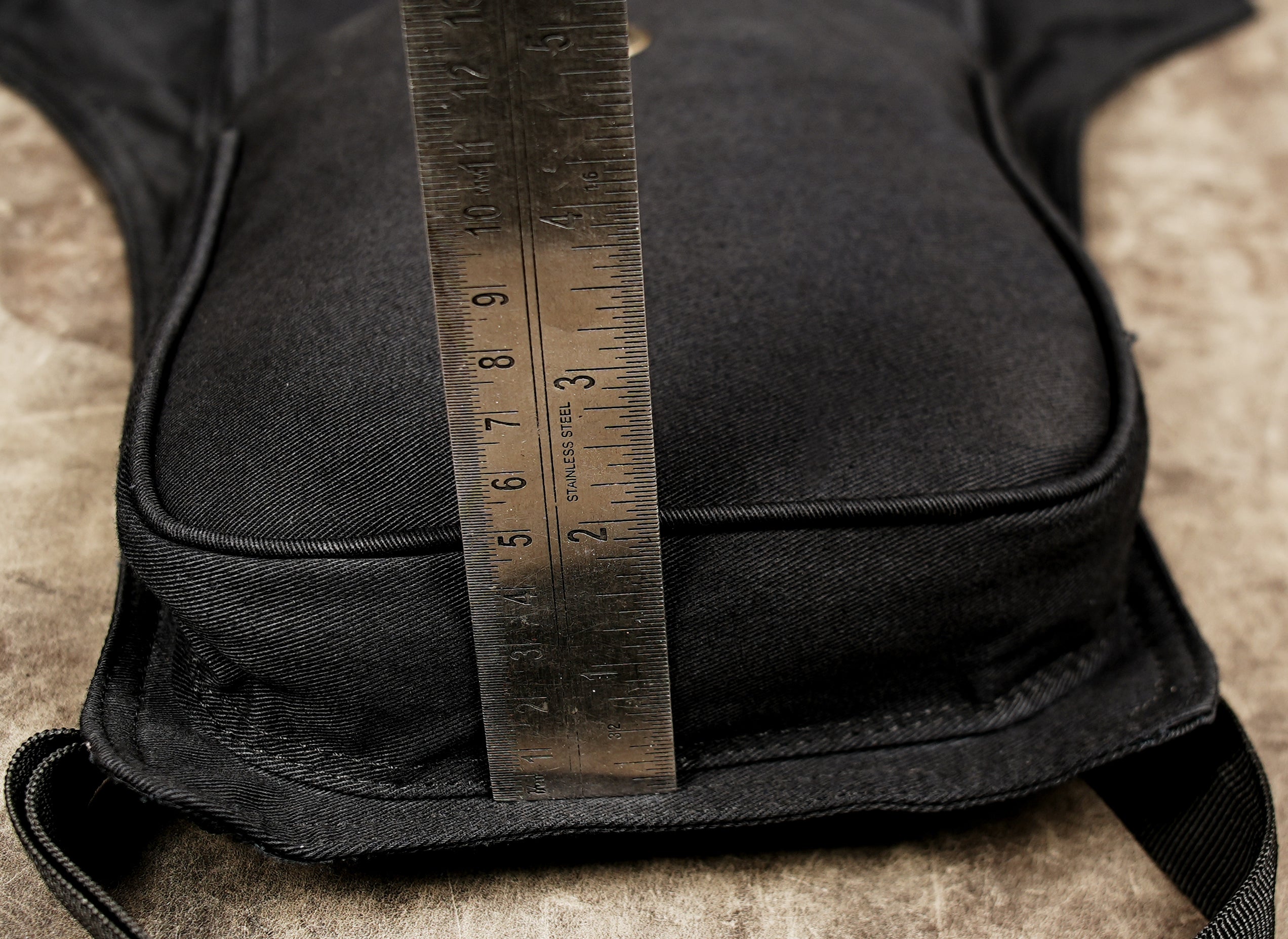 Black unisex leg bag with quick release buckle and adjustable belt.