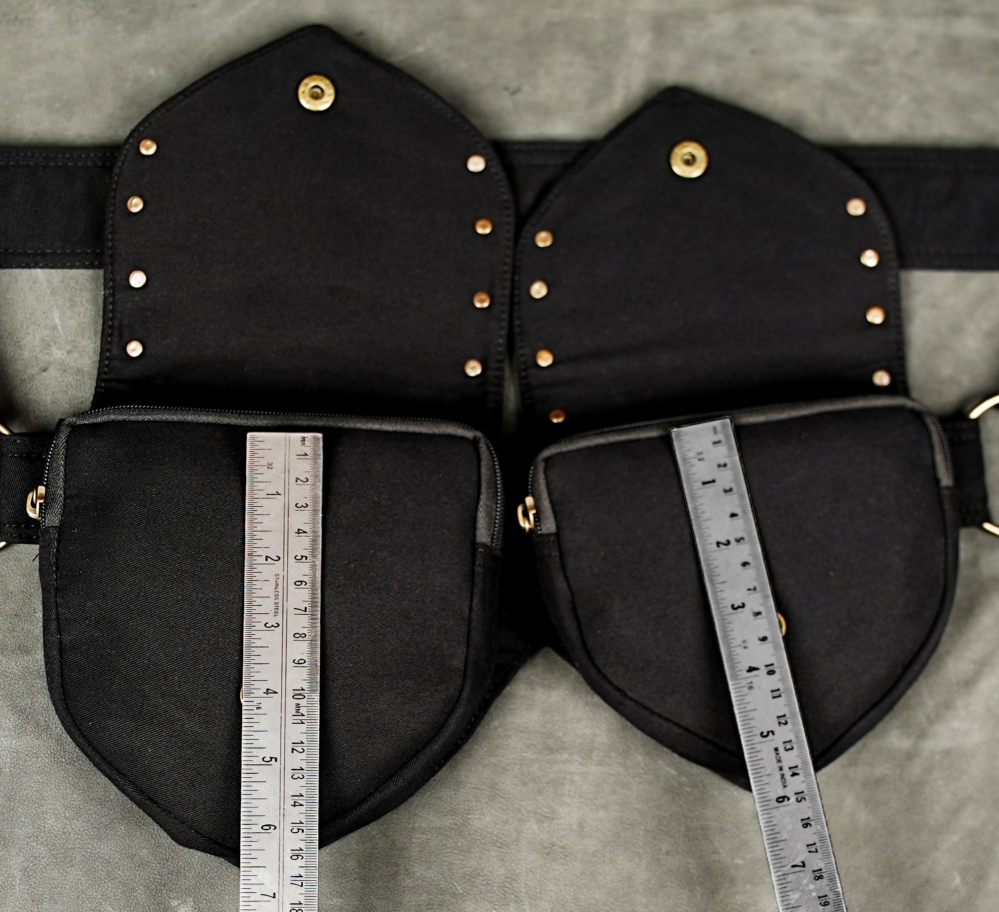 Black waist belt with two roomy pockets and bronze-tone brass hardware