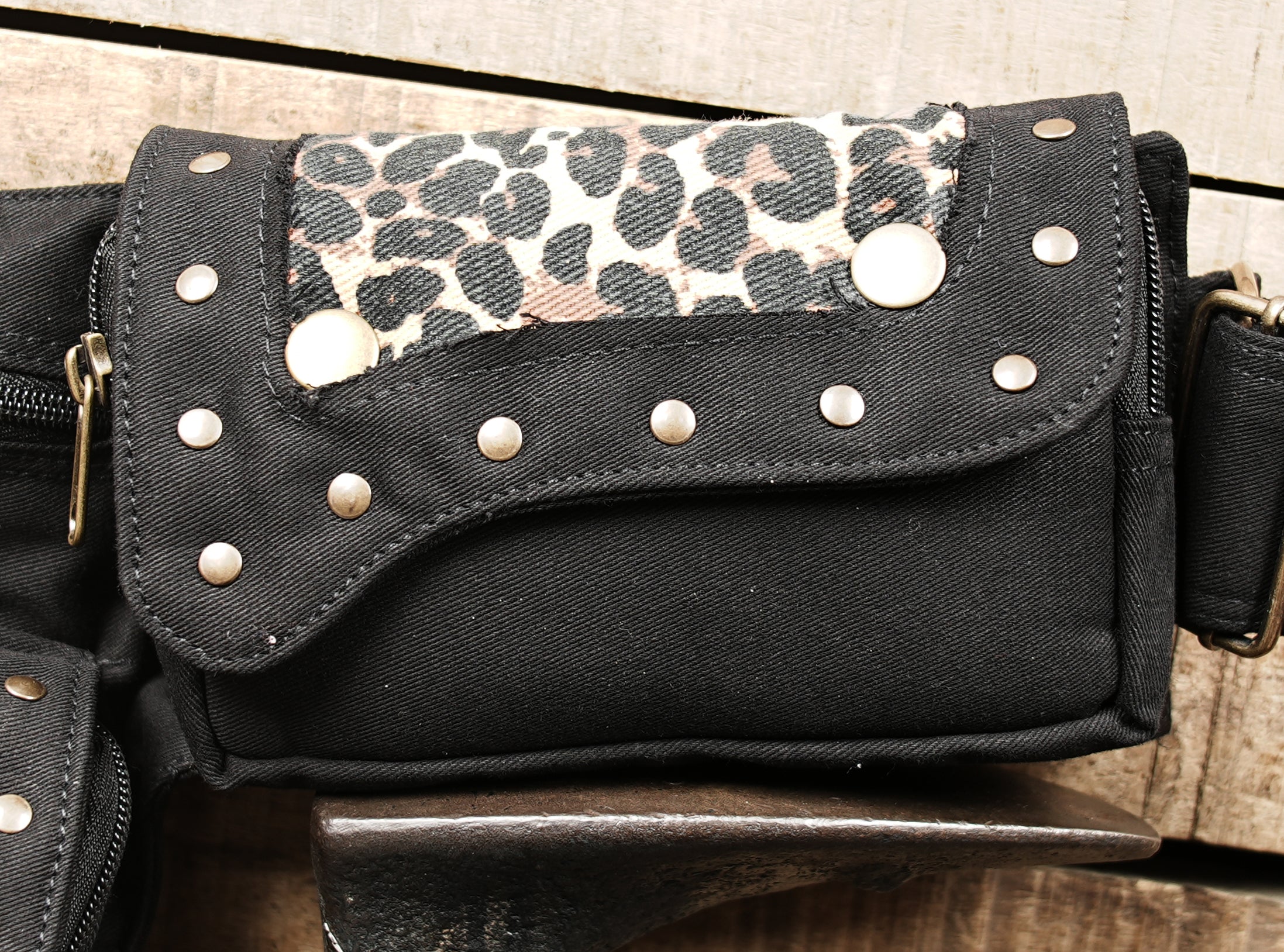 Inside compartments of leopard waist bag with essentials