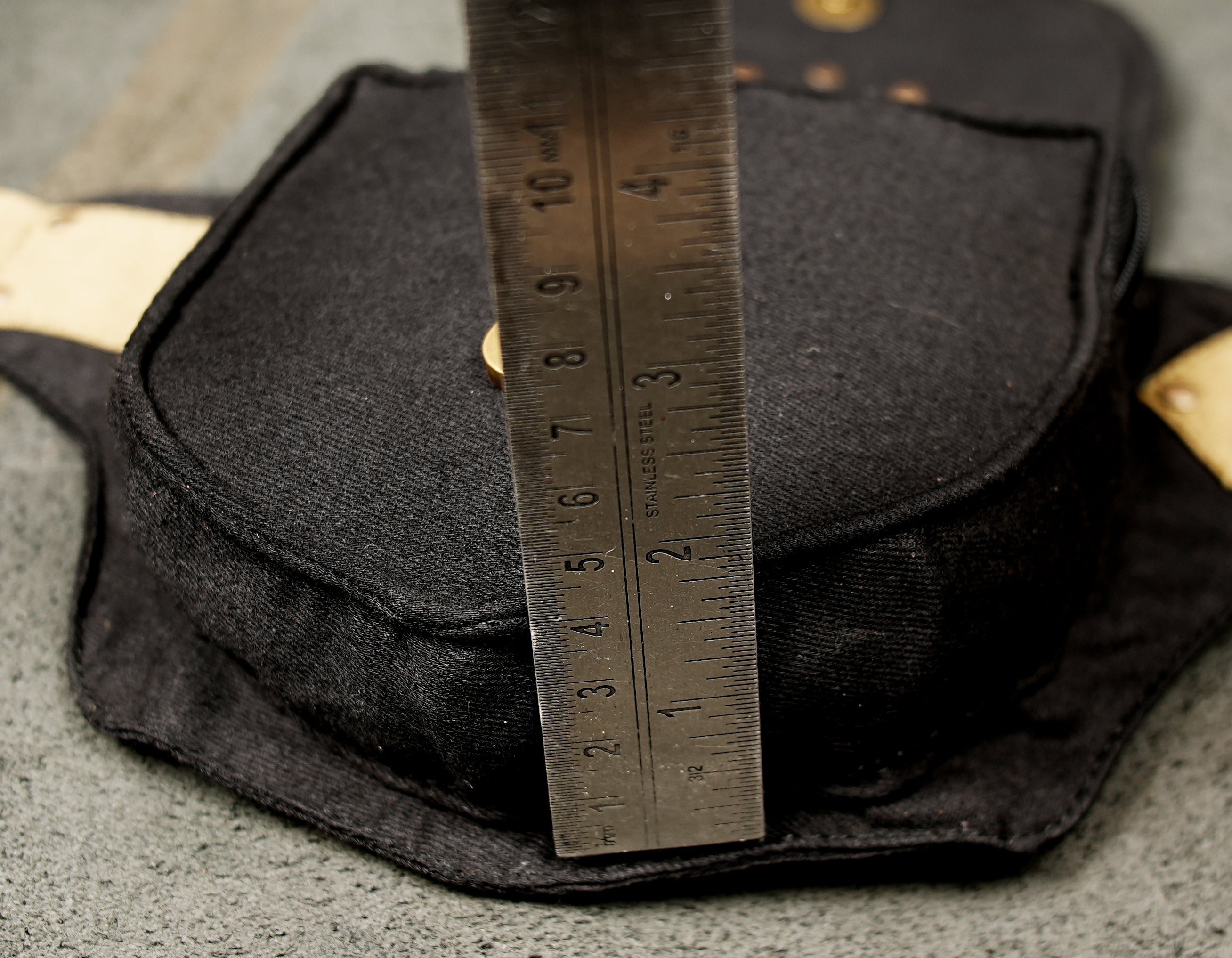 Flat lay of a handmade-style canvas fanny pack (USA) with contrasting natural-color trim.