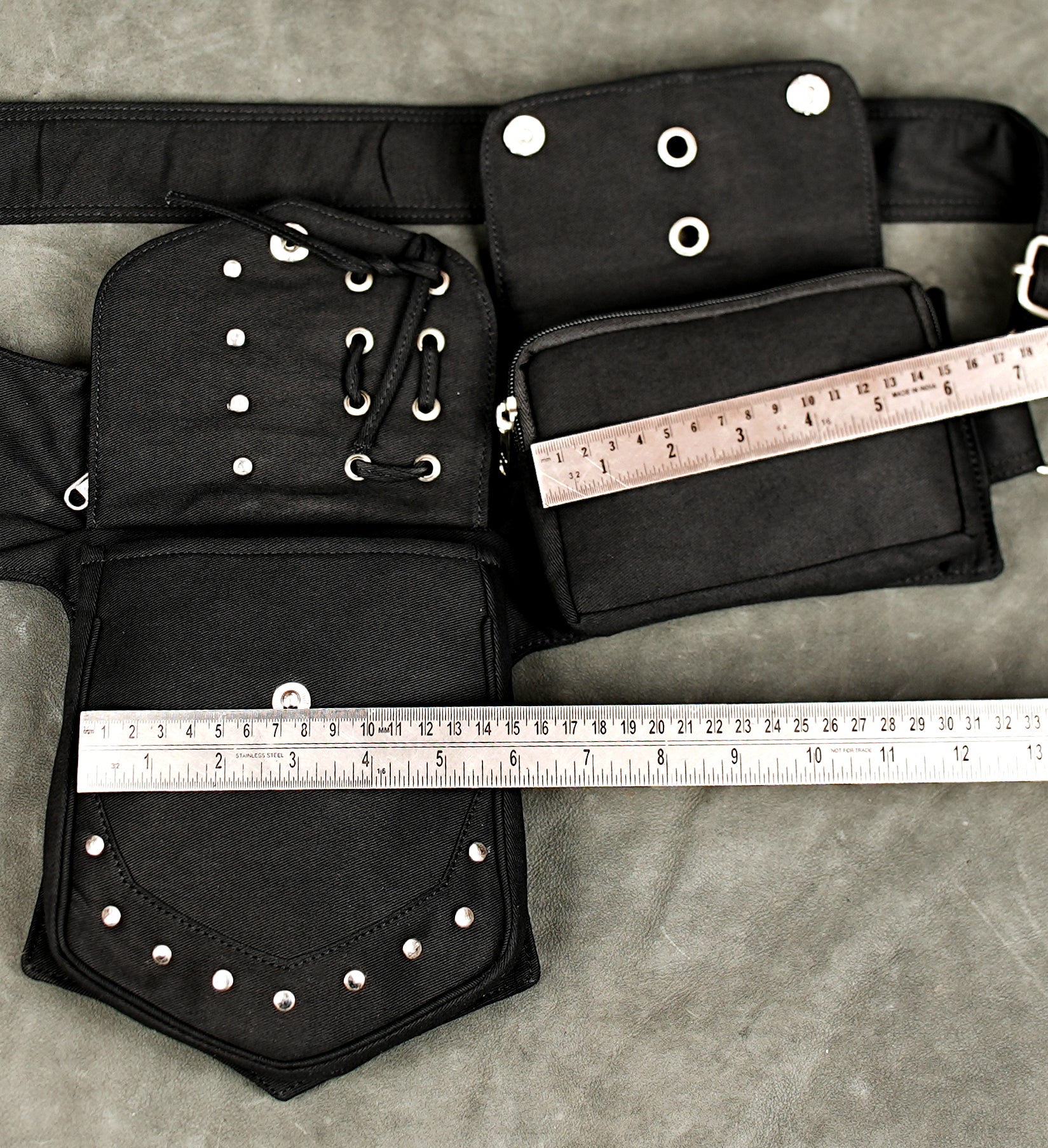 Black cotton steampunk waist belt with dual utility pouches metal rings and adjustable fastening.