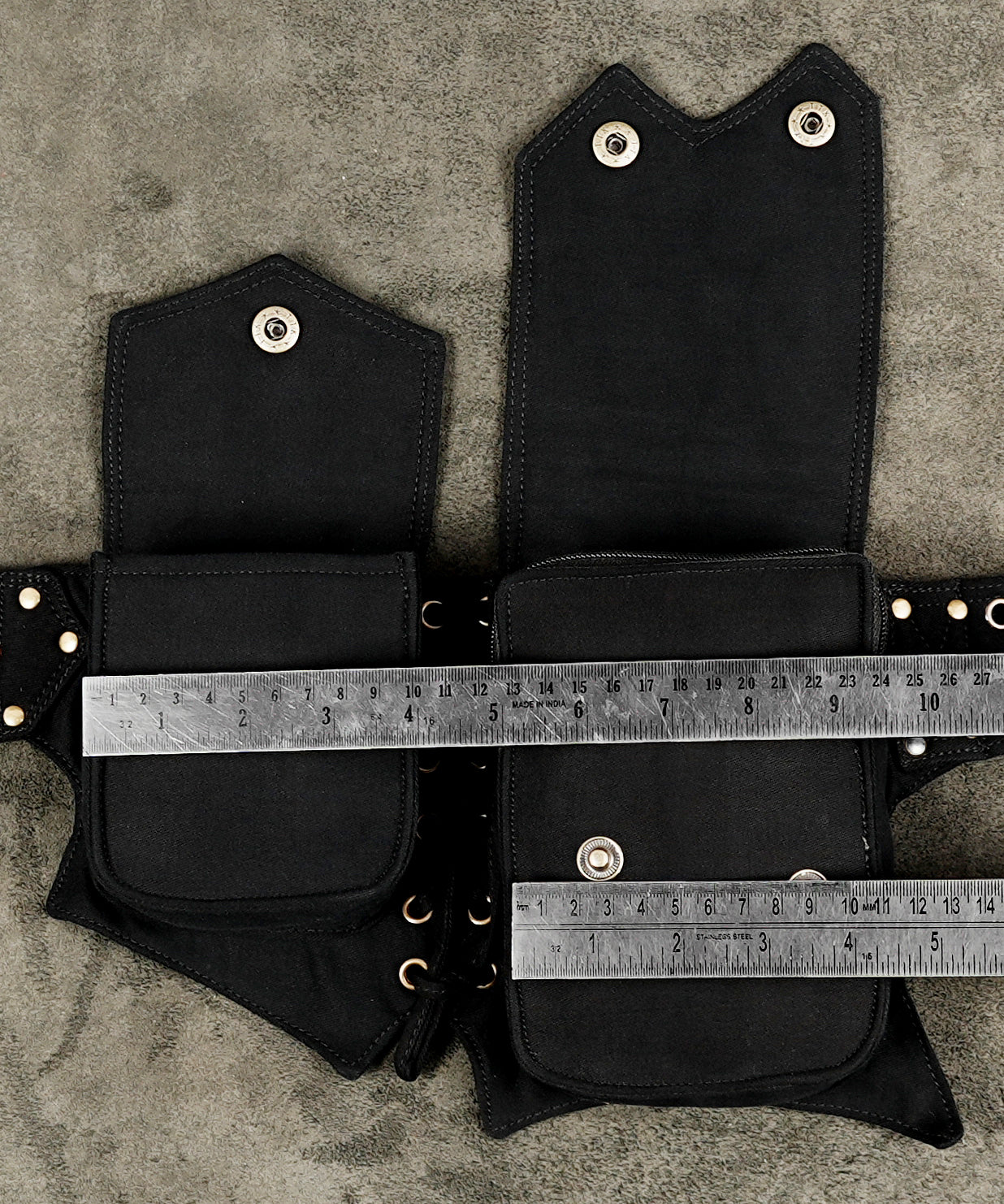 Black multi-pocket waist belt with adjustable fit and metal eyelets