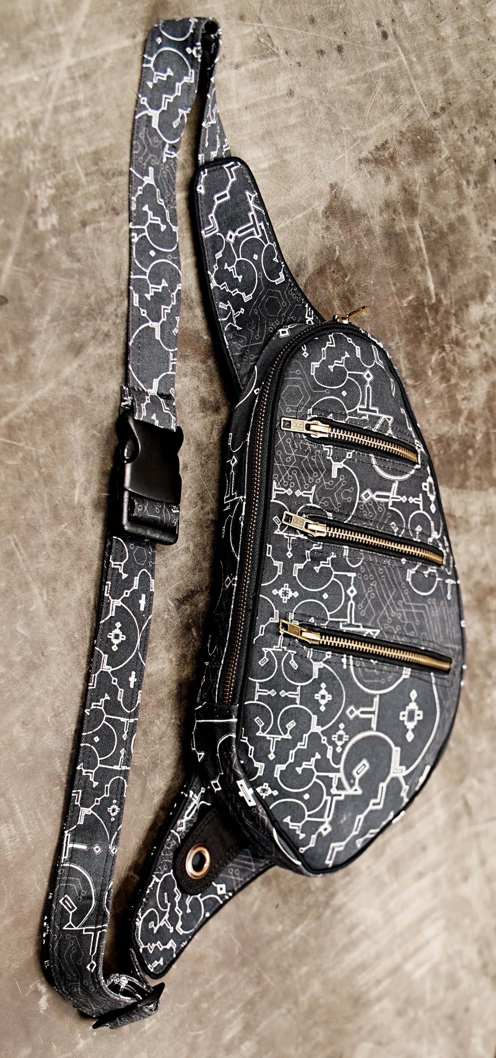 Sling bag strap with circuit print pattern and black buckle clasp