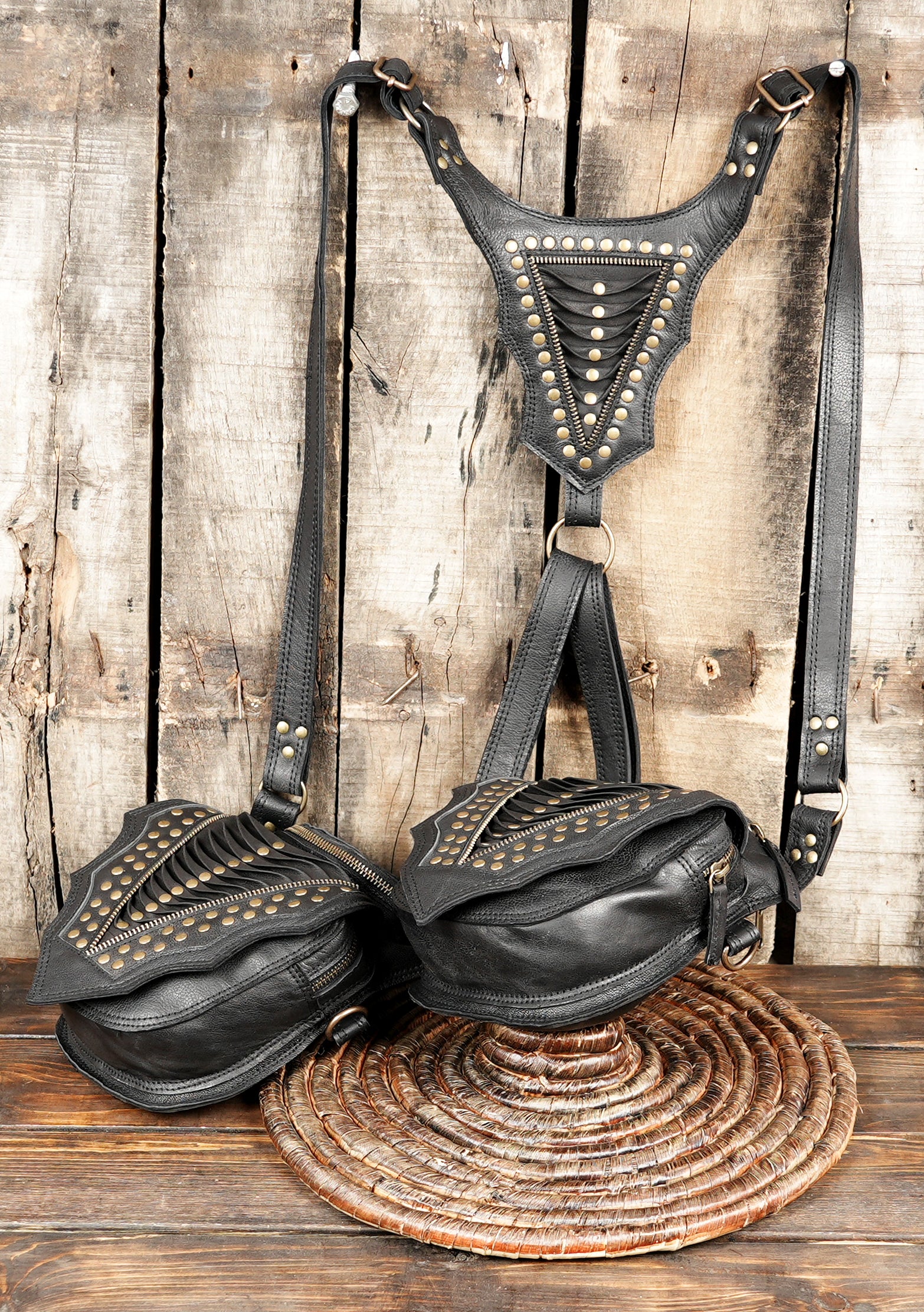 “Black leather utility holster with decorative stitching and metal hardware”