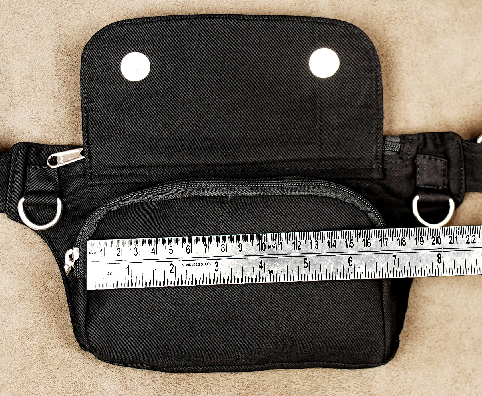 Functional black utility belt bag with a rugged finish and silver hardware.