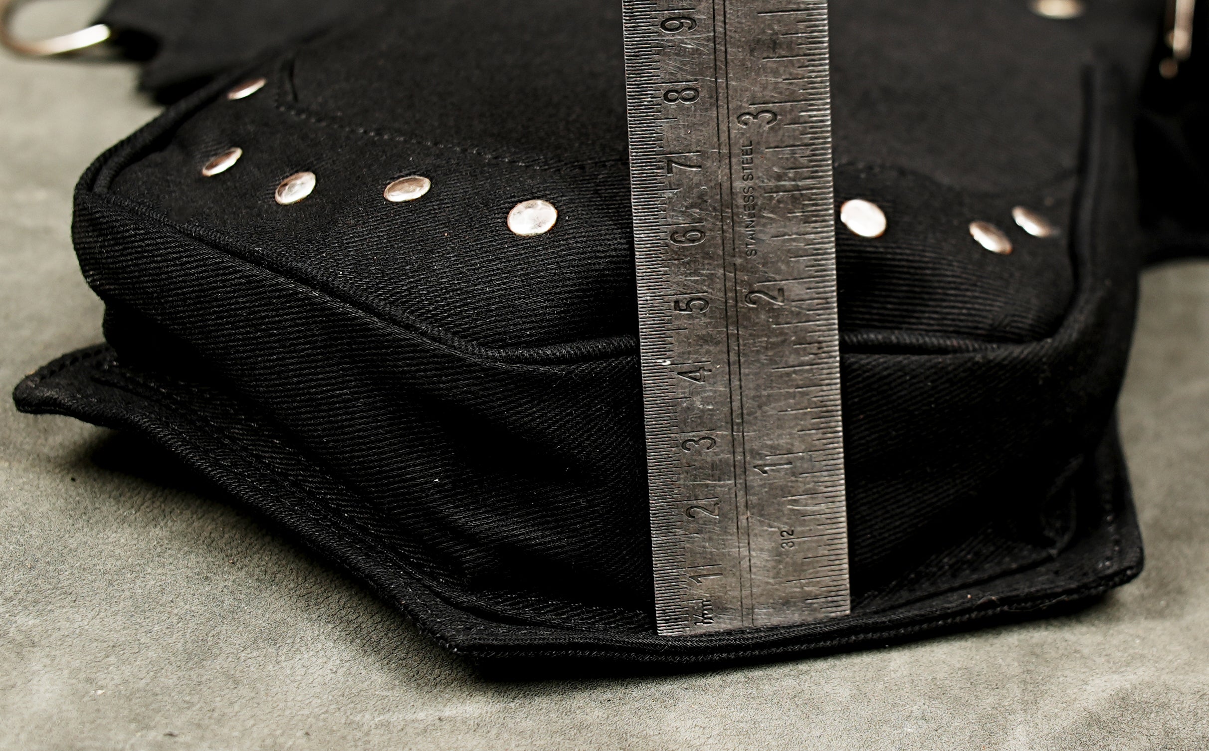 Unisex black cotton hip pouch belt with decorative studs and functional pockets for alternative streetwear.
