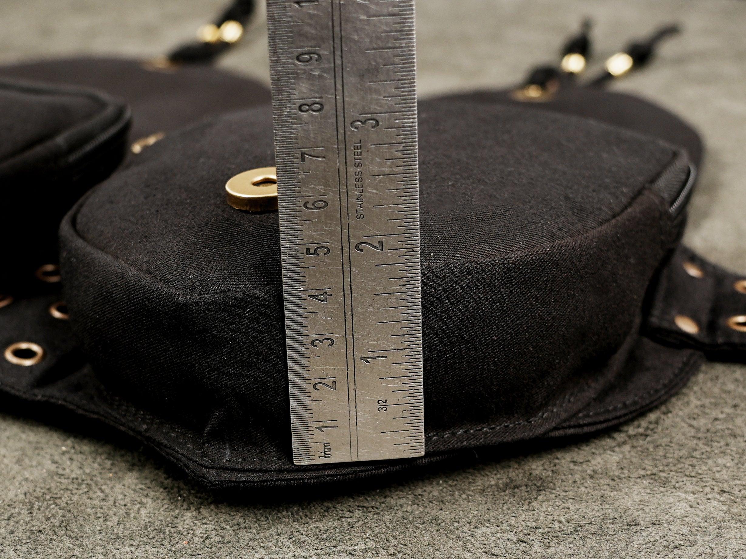 Canvas belt bag with grommet detailing, shown fully extended