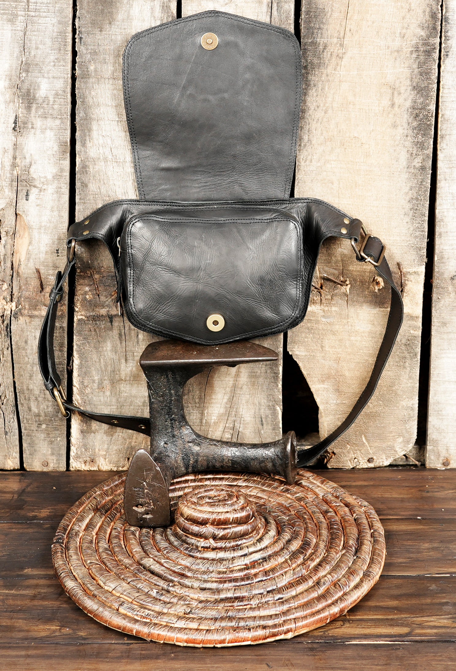 Black leather utility belt bag featuring handcrafted stone design