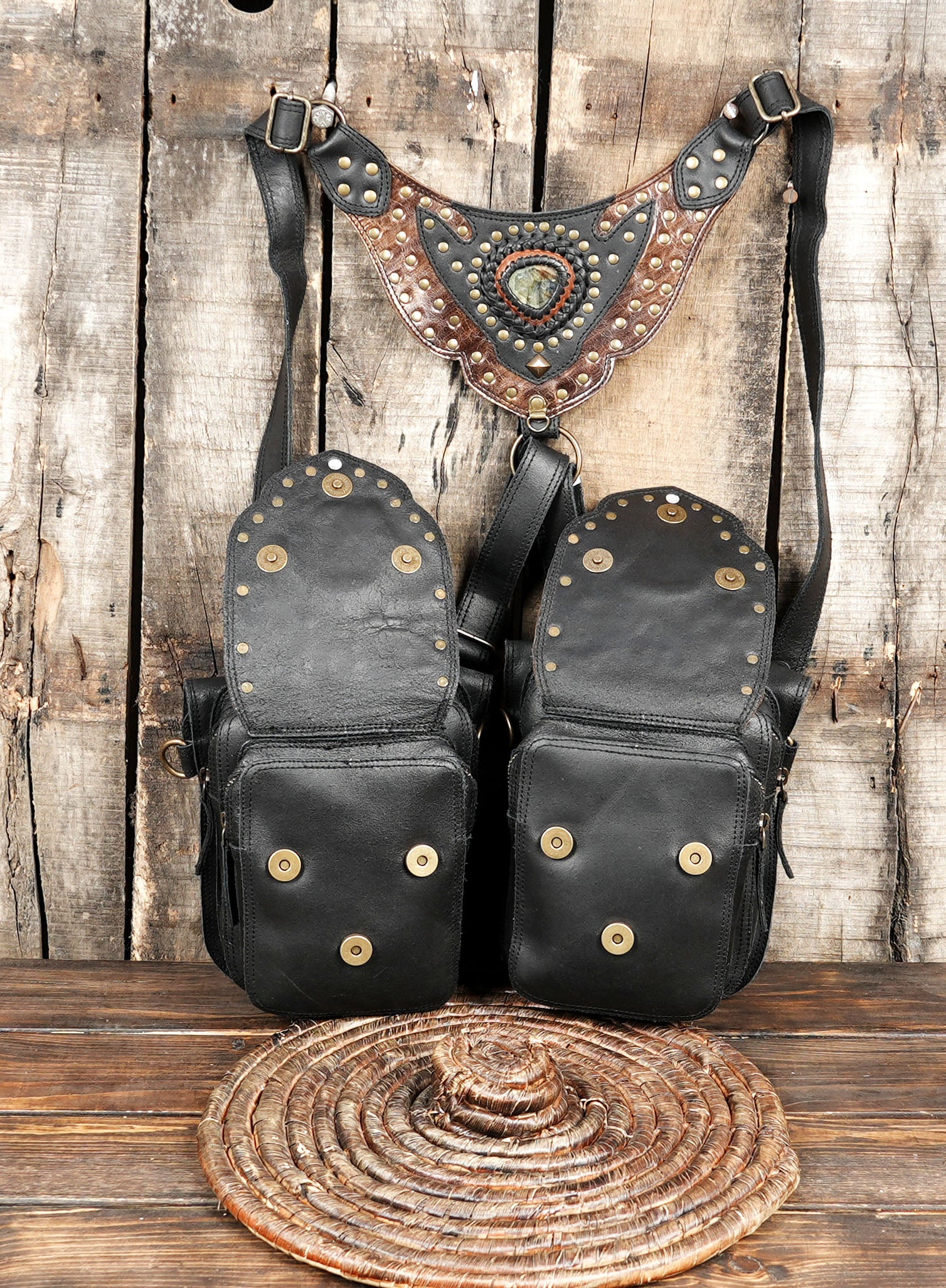 “Premium leather hip holster with embossed detailing and stone inlay on wooden background”