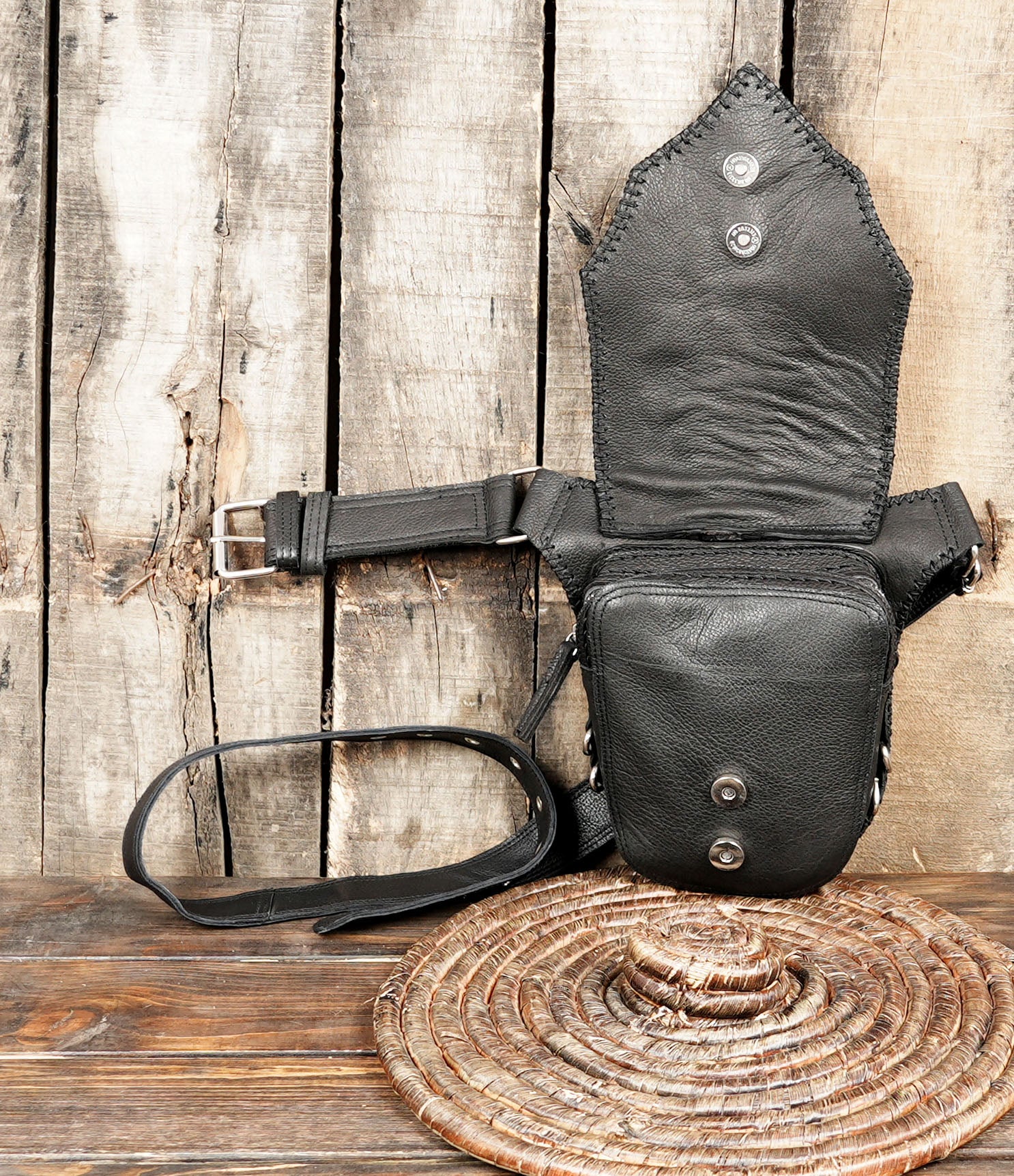 Black leather belt with studded design and horn accent